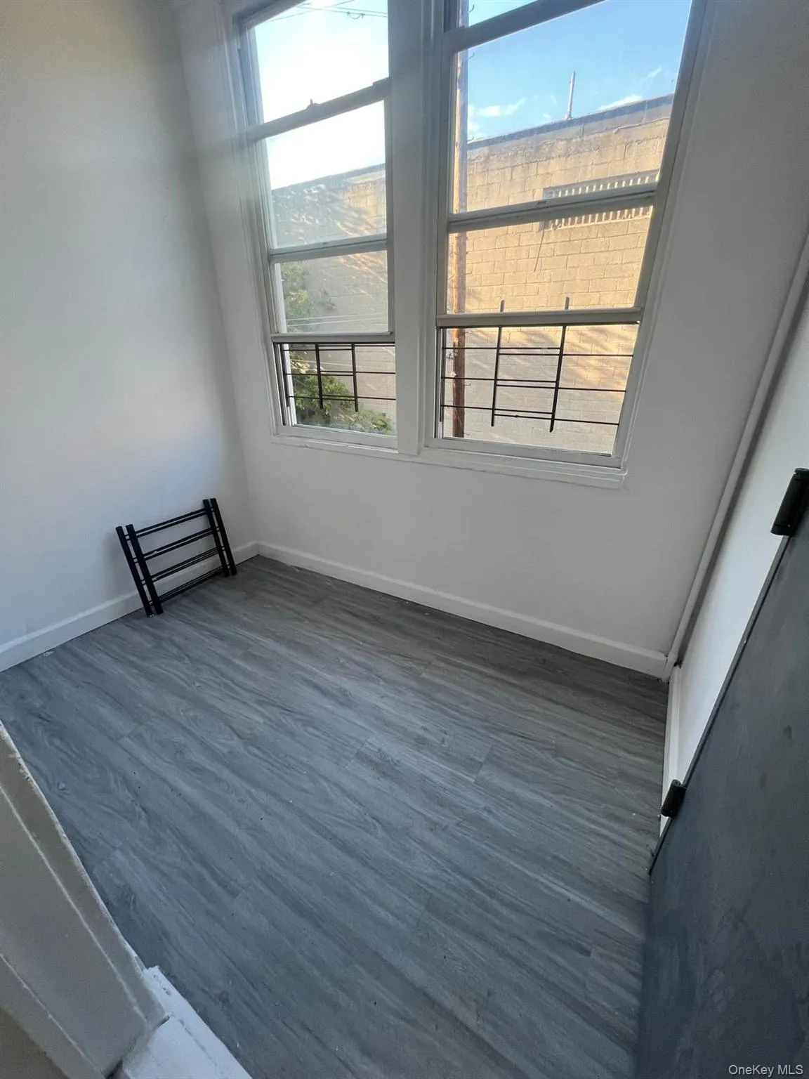 Spare room with dark wood finished floors and baseboards Spare room with dark wood finished floors and baseboards