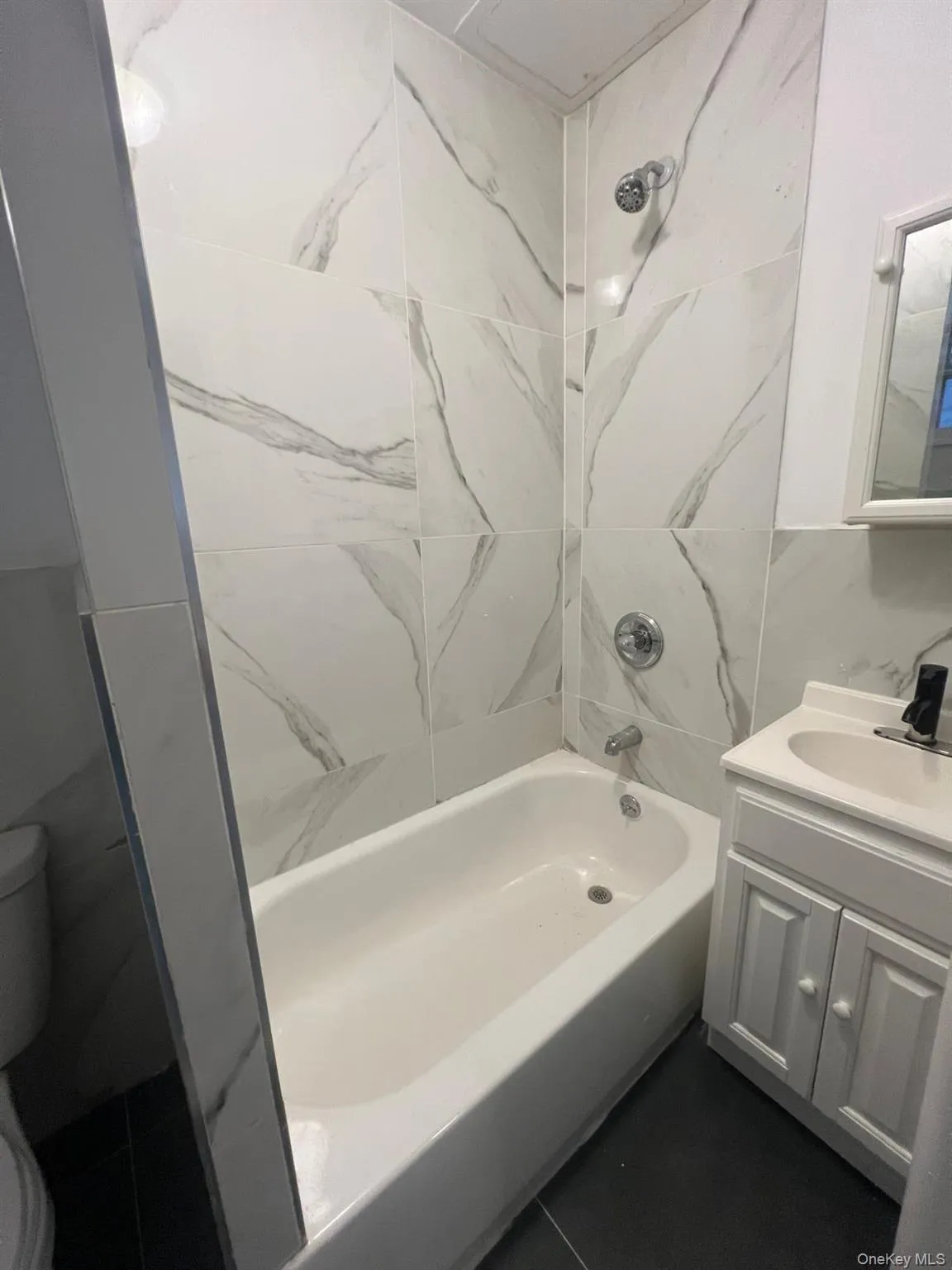 Full bathroom with shower / washtub combination and vanity Full bathroom with shower / washtub combination and vanity