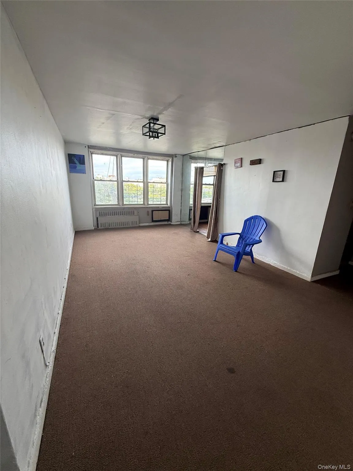 Unfurnished room featuring carpet floors and radiator Unfurnished room featuring carpet floors and radiator