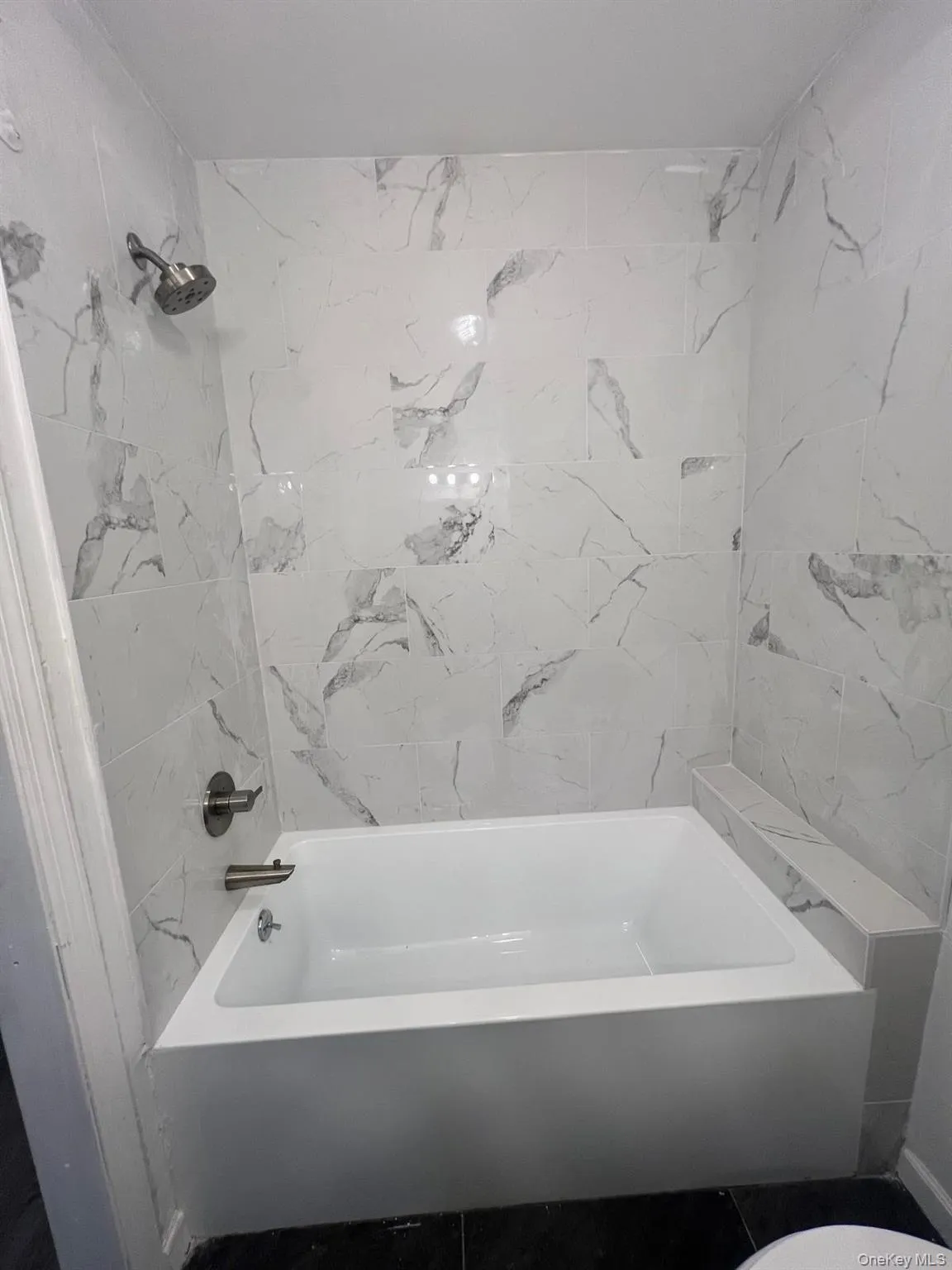 Full bathroom with bathing tub / shower combination and toilet Full bathroom with bathing tub / shower combination and toilet