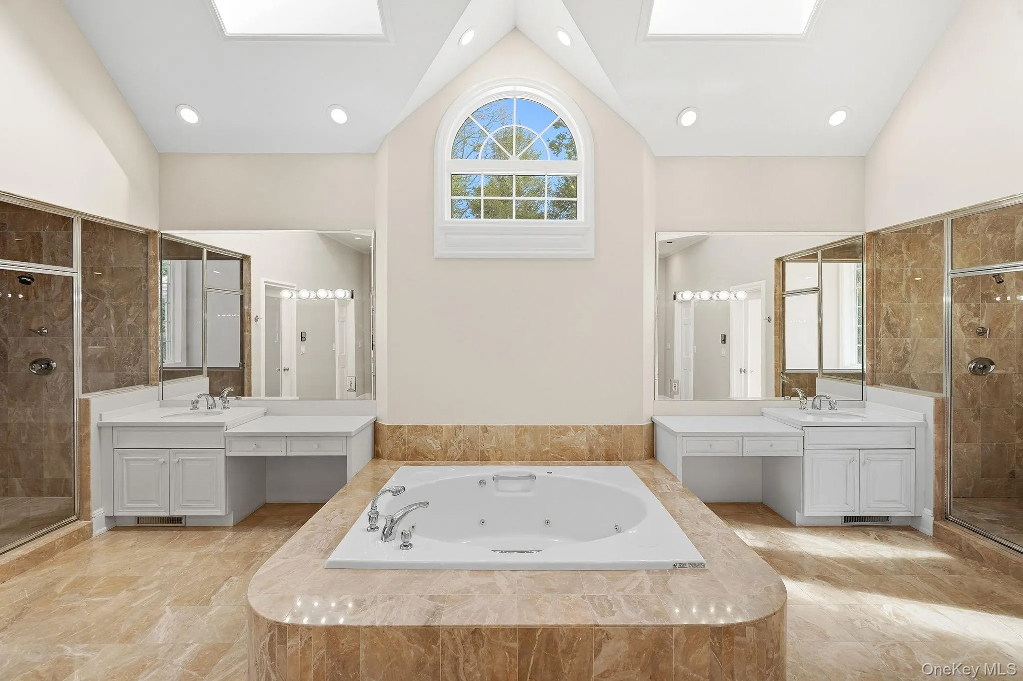 Spa-like primary bathroom with 18 foot high cathedral ceiling featuring two vanities, two steam showers, two water closets, a sumptuous jacuzzi and two spacious walk-in closets Spa-like primary bathroom with 18 foot high cathedral ceiling featuring two vanities, two steam showers, two water closets, a sumptuous jacuzzi and two spacious walk-in closets