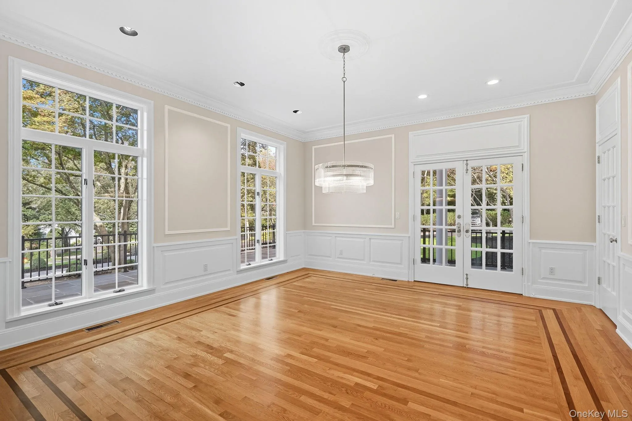 Formal dining room with french doors opening to a side flagstone terrace Formal dining room with french doors opening to a side flagstone terrace