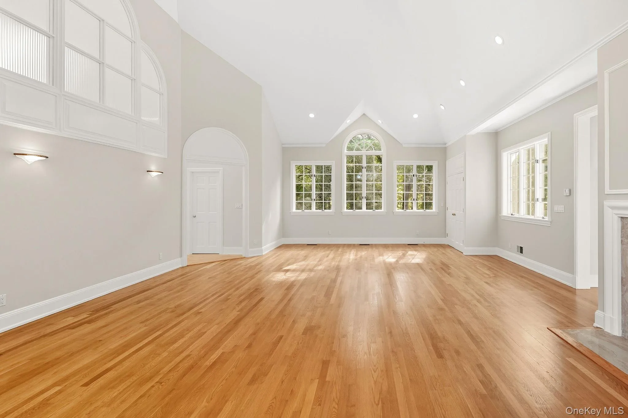 Primary bedroom with an 18 foot high cathedral ceiling and a wood burning fireplace Primary bedroom with an 18 foot high cathedral ceiling and a wood burning fireplace