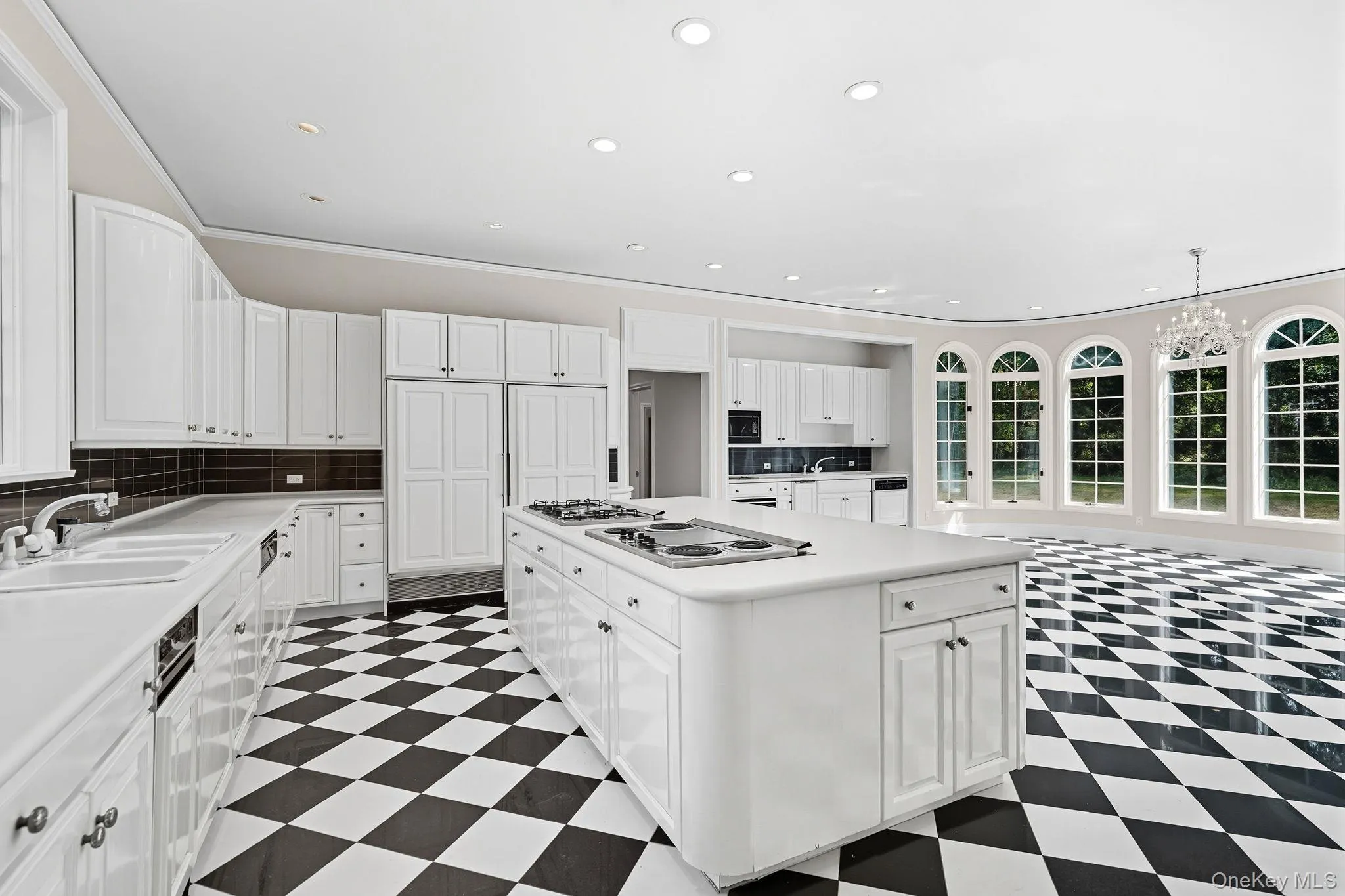Spectacular gourmet chef's eat-in-kitchen with marble countertops and floors, oversized island with both gas and electric cooktops and a sun-drenched dining area with bay windows and french doors opening to the terrace, pool and magnificent lush private grounds Spectacular gourmet chef's eat-in-kitchen with marble countertops and floors, oversized island with both gas and electric cooktops and a sun-drenched dining area with bay windows and french doors opening to the terrace, pool and magnificent lush private grounds