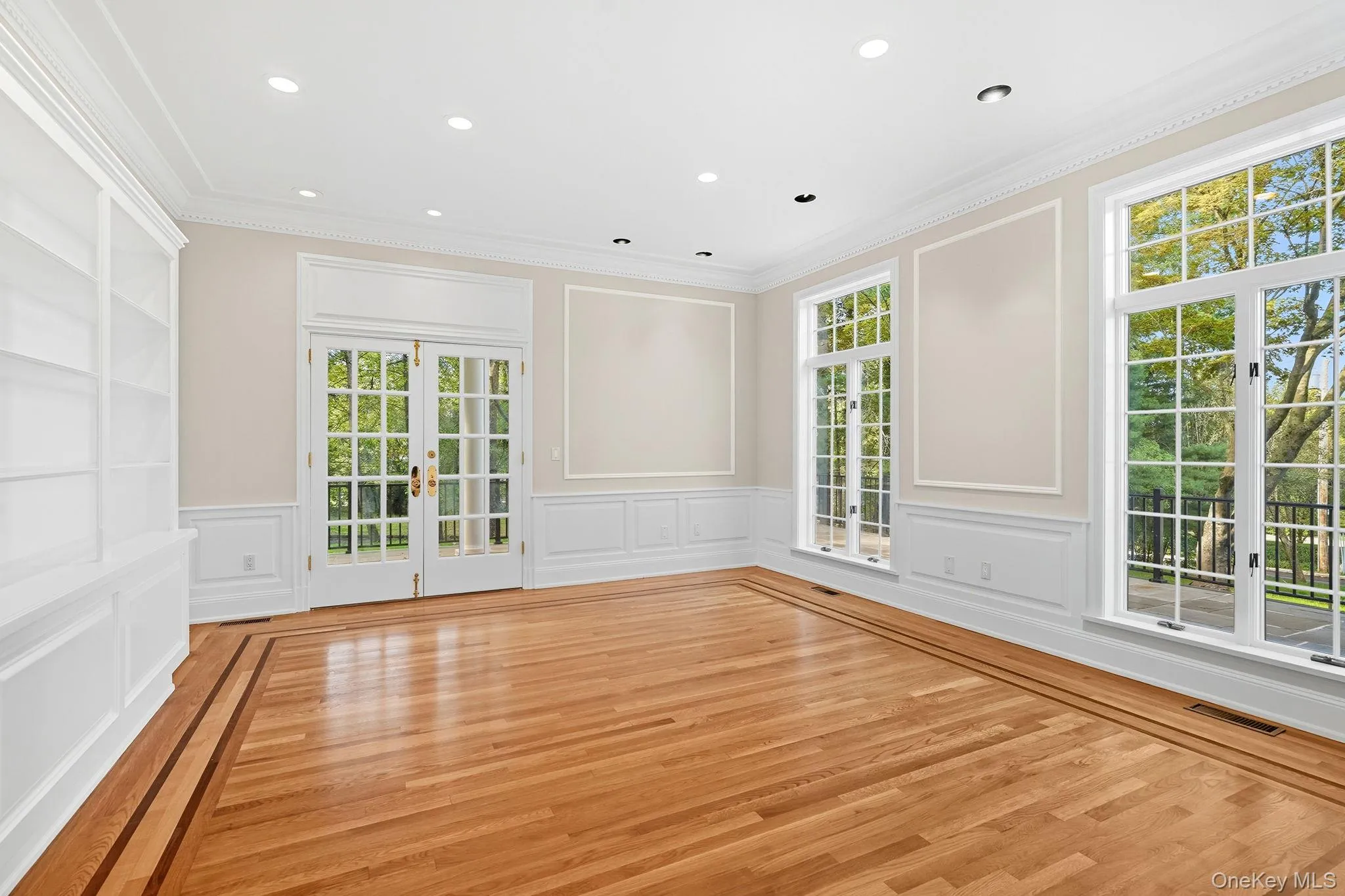 Study with custom built-ins with french doors opening to a side flagstone terrace Study with custom built-ins with french doors opening to a side flagstone terrace