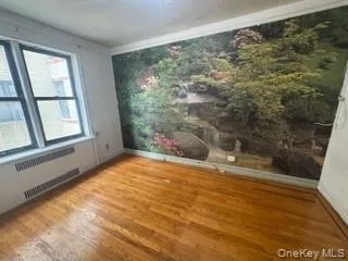 Spare room featuring wood finished floors and ornamental molding Spare room featuring wood finished floors and ornamental molding