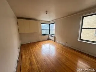 Unfurnished room featuring light wood-style flooring and baseboards Unfurnished room featuring light wood-style flooring and baseboards