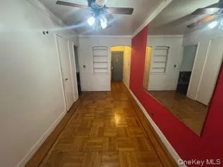Hallway featuring ornamental molding and arched walkways Hallway featuring ornamental molding and arched walkways