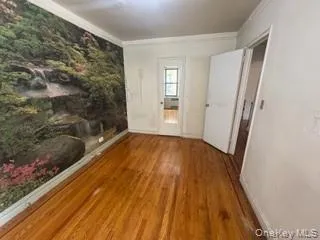 Empty room with wood finished floors and crown molding Empty room with wood finished floors and crown molding