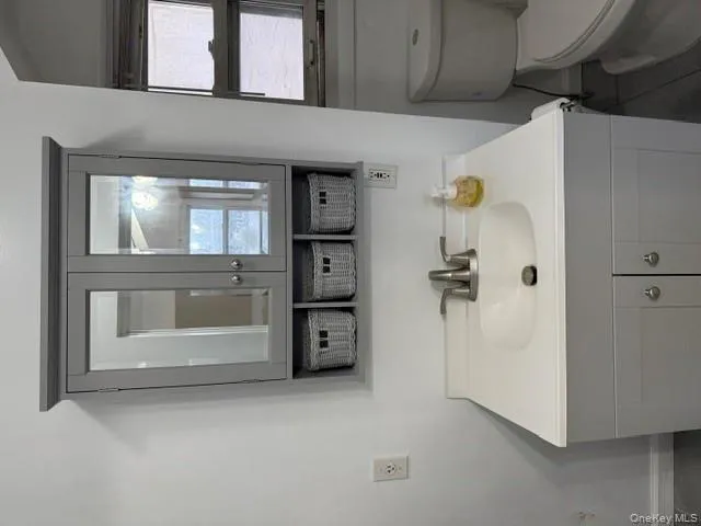 Bathroom featuring vanity and dark tile patterned flooring Bathroom featuring vanity and dark tile patterned flooring