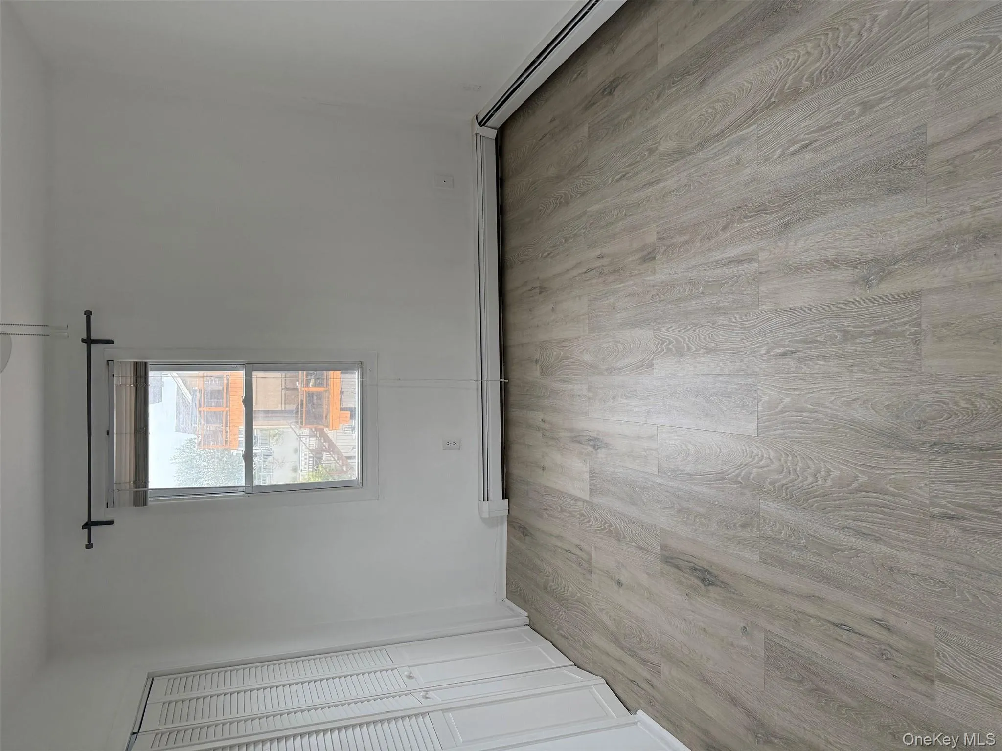 Unfurnished bedroom with light wood-style floors, baseboard heating, and a closet Unfurnished bedroom with light wood-style floors, baseboard heating, and a closet