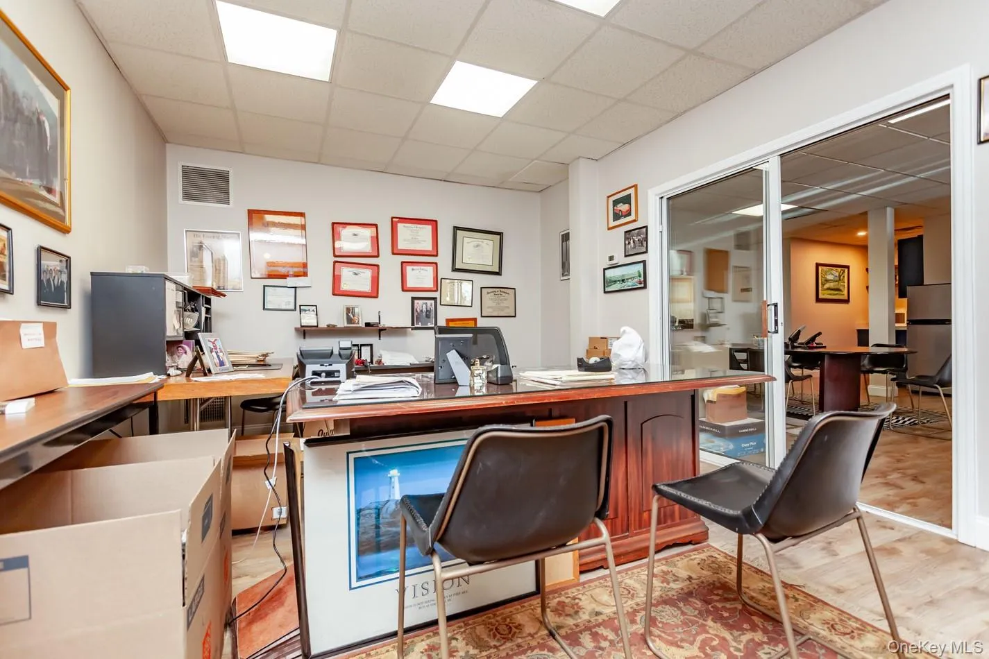 Office featuring a drop ceiling and light wood-type flooring Office featuring a drop ceiling and light wood-type flooring