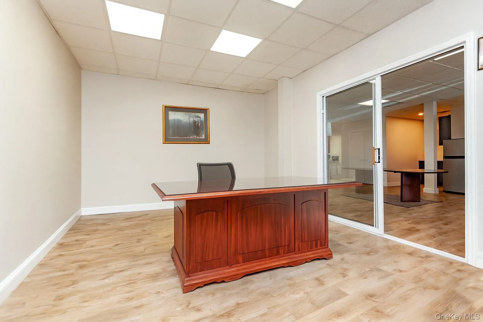 (Digitally Decluttered) Unfurnished office featuring a drop ceiling and light wood finished floors (Digitally Decluttered) Unfurnished office featuring a drop ceiling and light wood finished floors