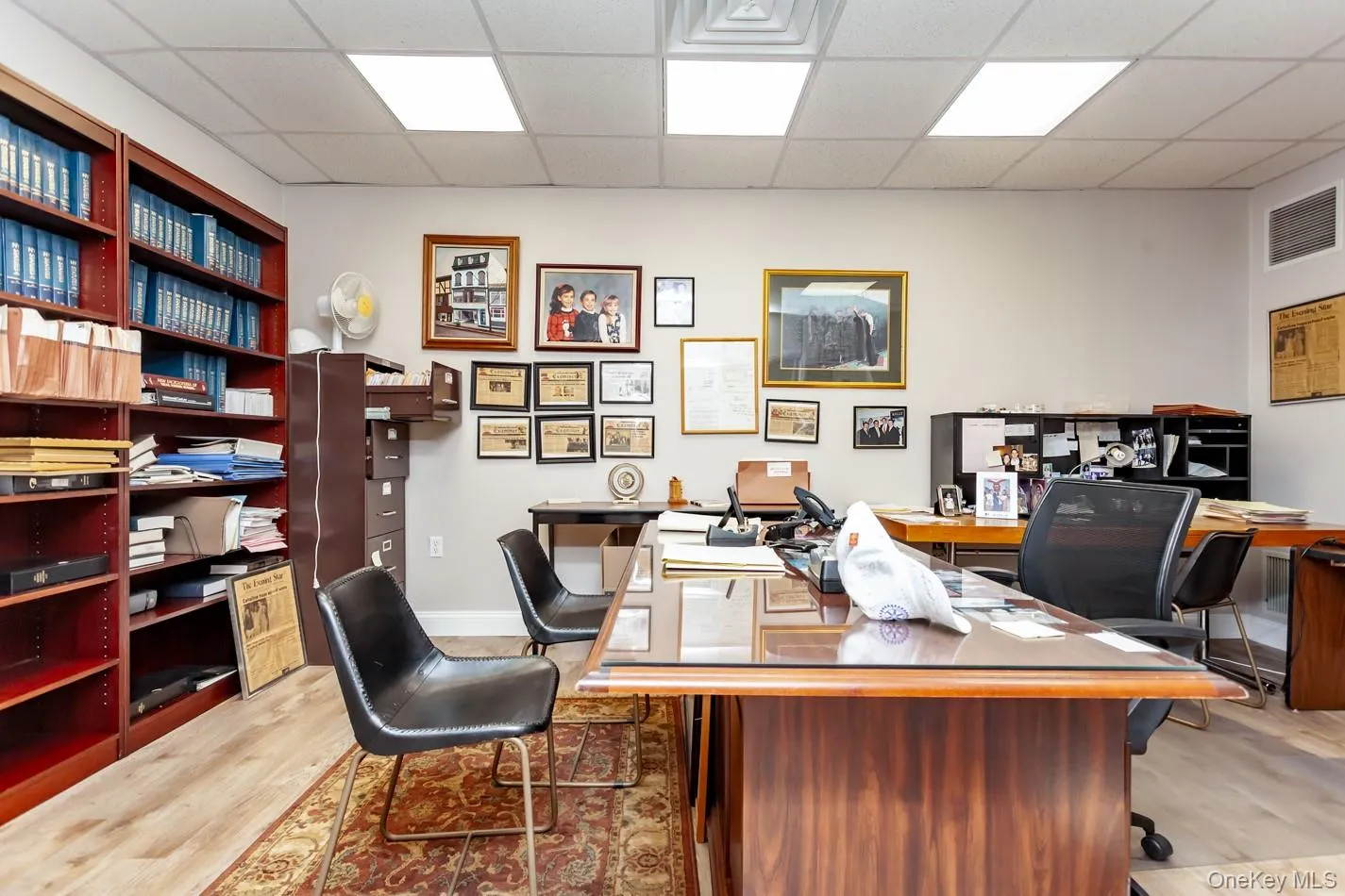 Office with a paneled ceiling and light wood finished floors Office with a paneled ceiling and light wood finished floors