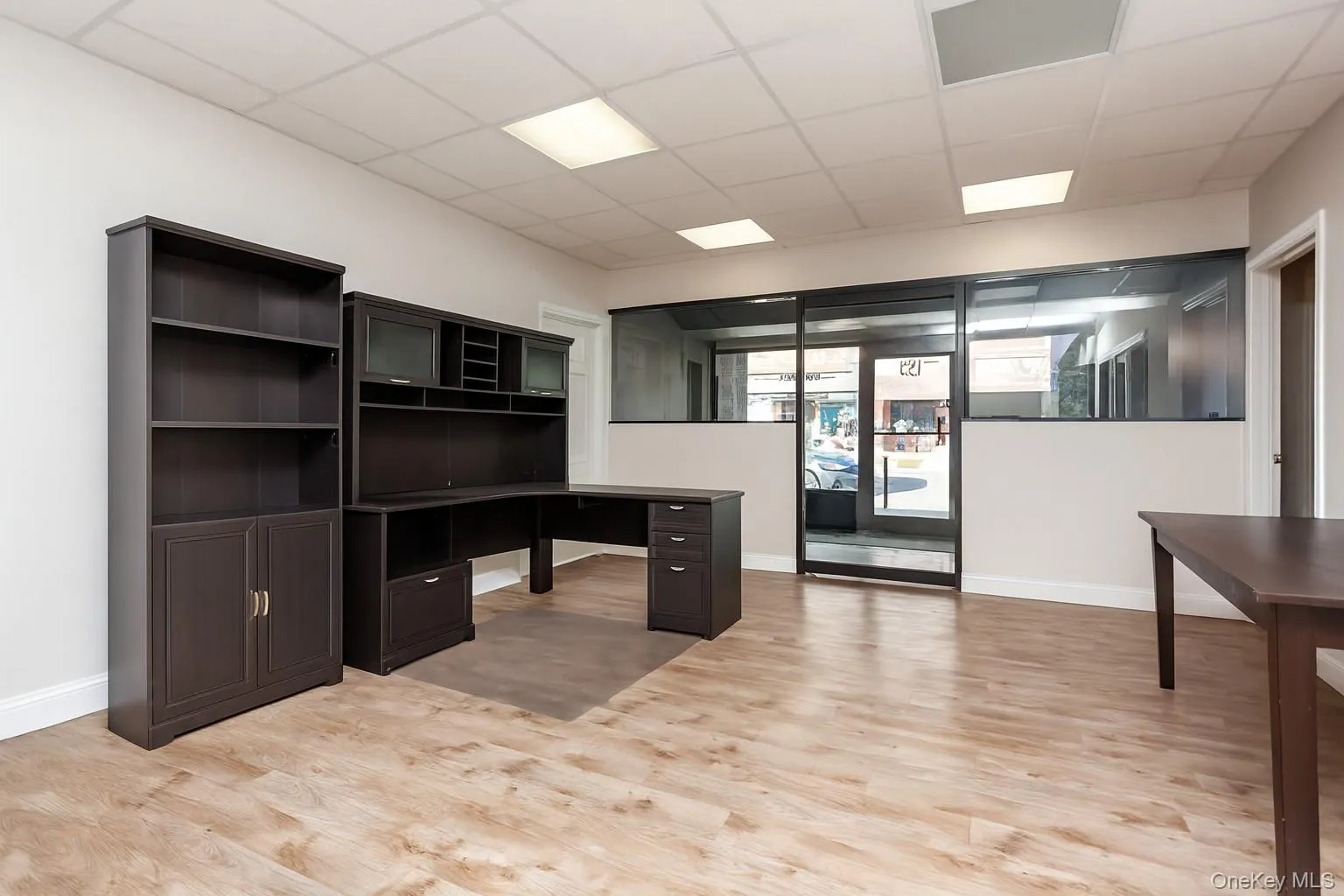 (Digitally Decluttered) Unfurnished office with a drop ceiling and light wood-style floors (Digitally Decluttered) Unfurnished office with a drop ceiling and light wood-style floors