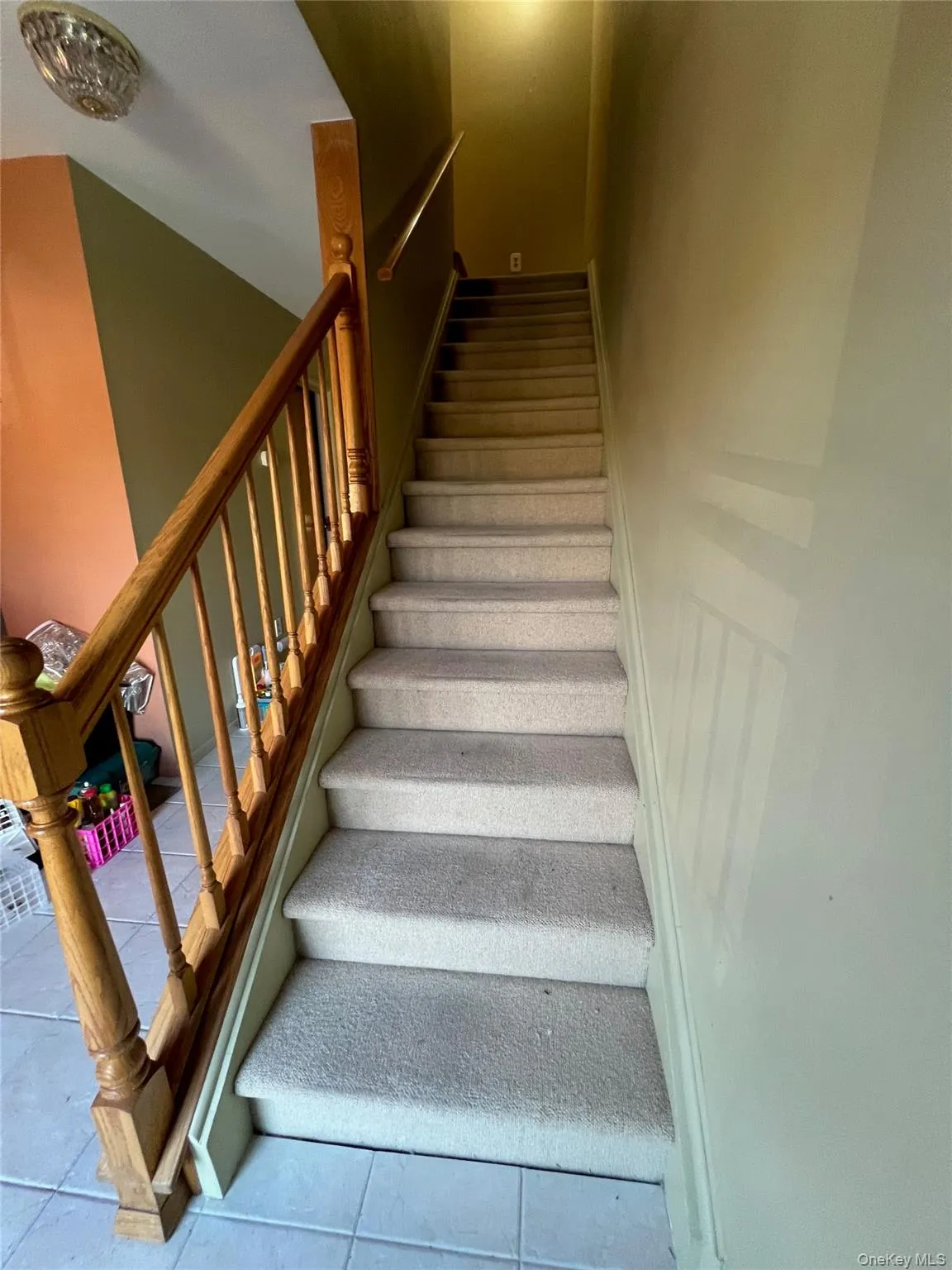 Stairway featuring tile patterned floors Stairway featuring tile patterned floors