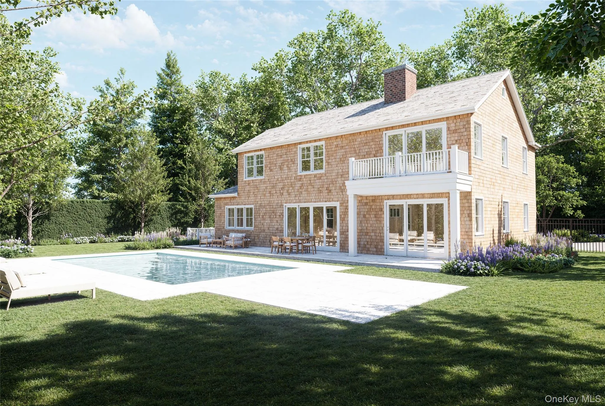 Back of house with a patio, a balcony, a chimney, and view of scattered trees Back of house with a patio, a balcony, a chimney, and view of scattered trees
