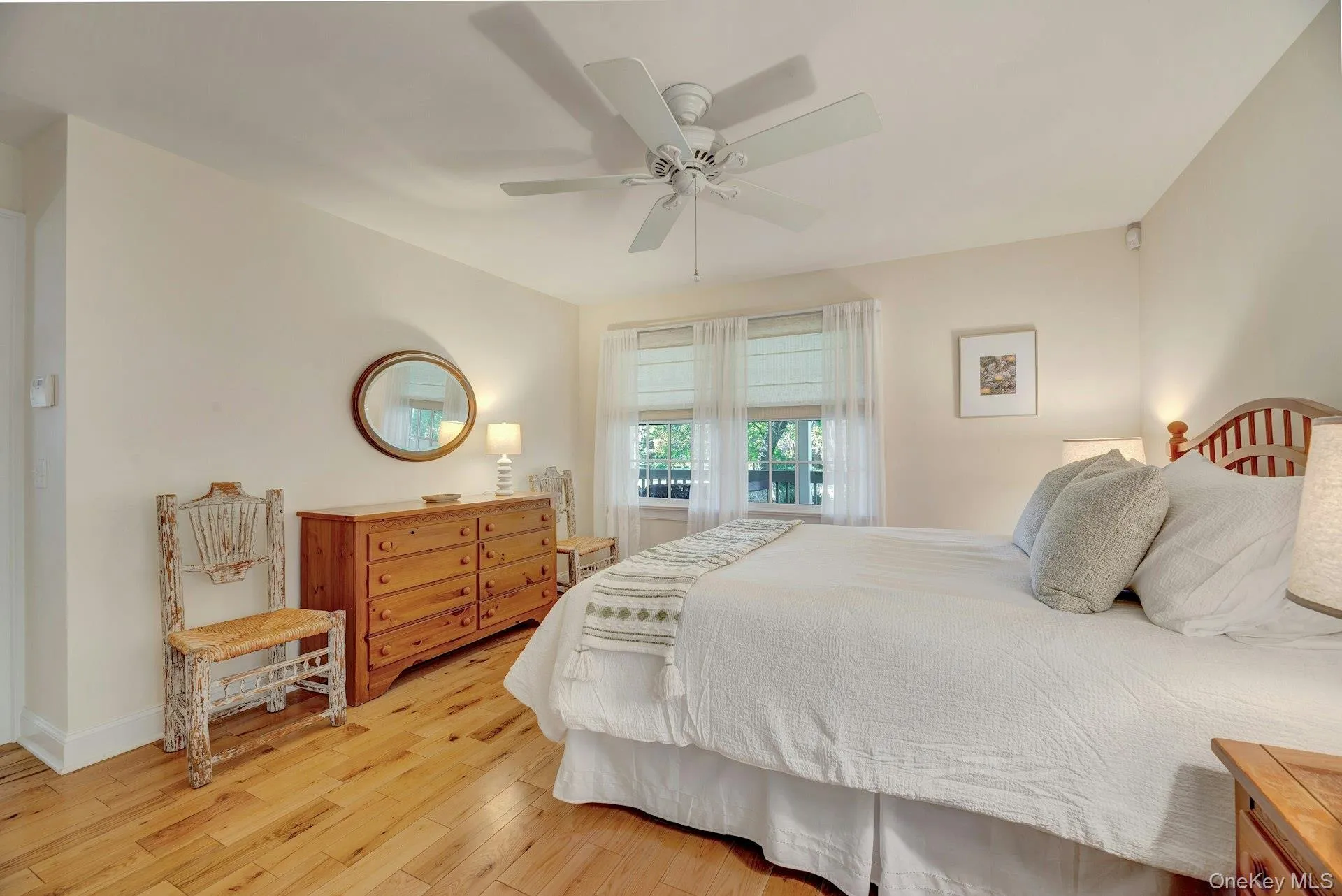 Bedroom featuring light wood finished floors and ceiling fan Bedroom featuring light wood finished floors and ceiling fan