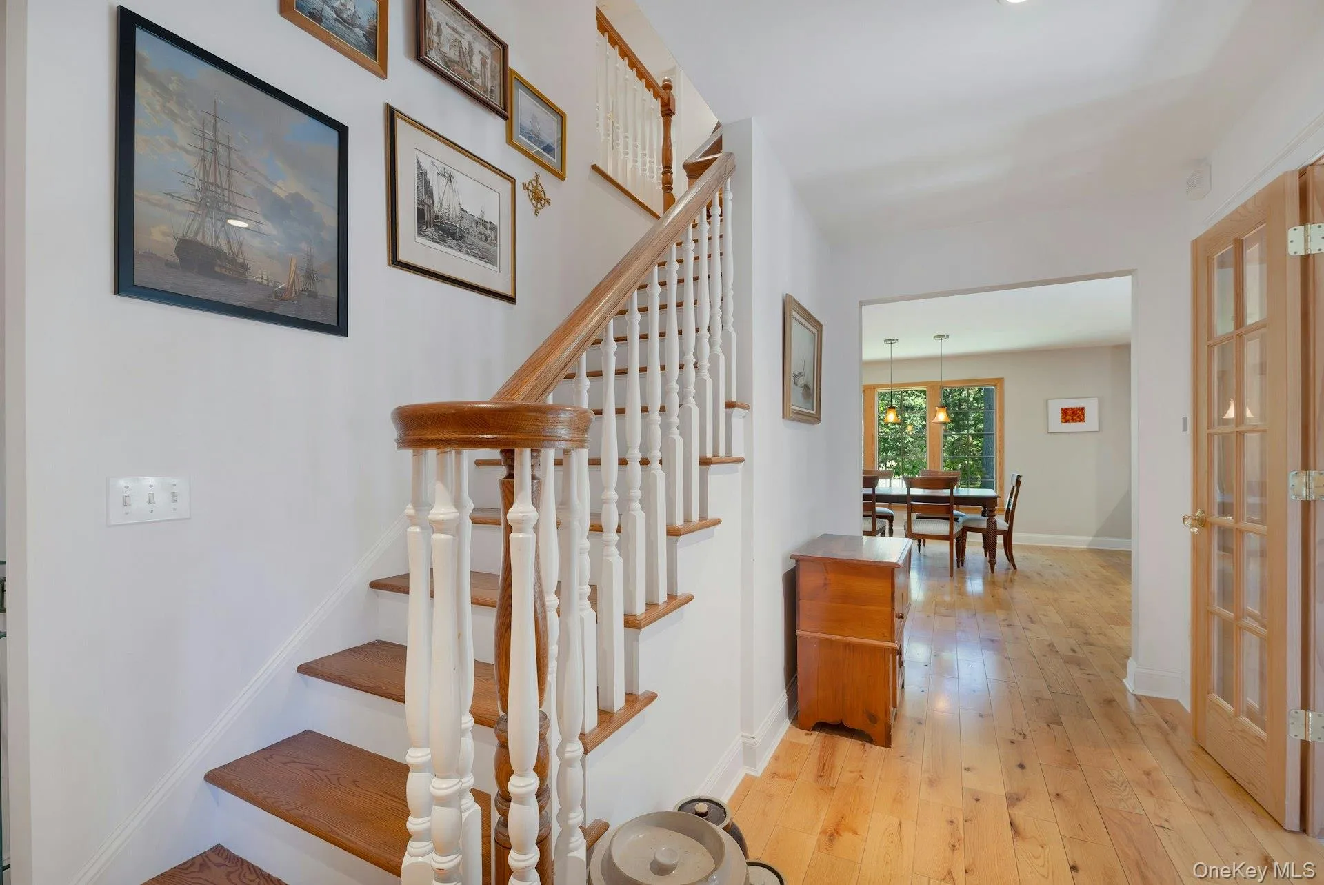 Staircase featuring hardwood / wood-style floors and baseboards Staircase featuring hardwood / wood-style floors and baseboards