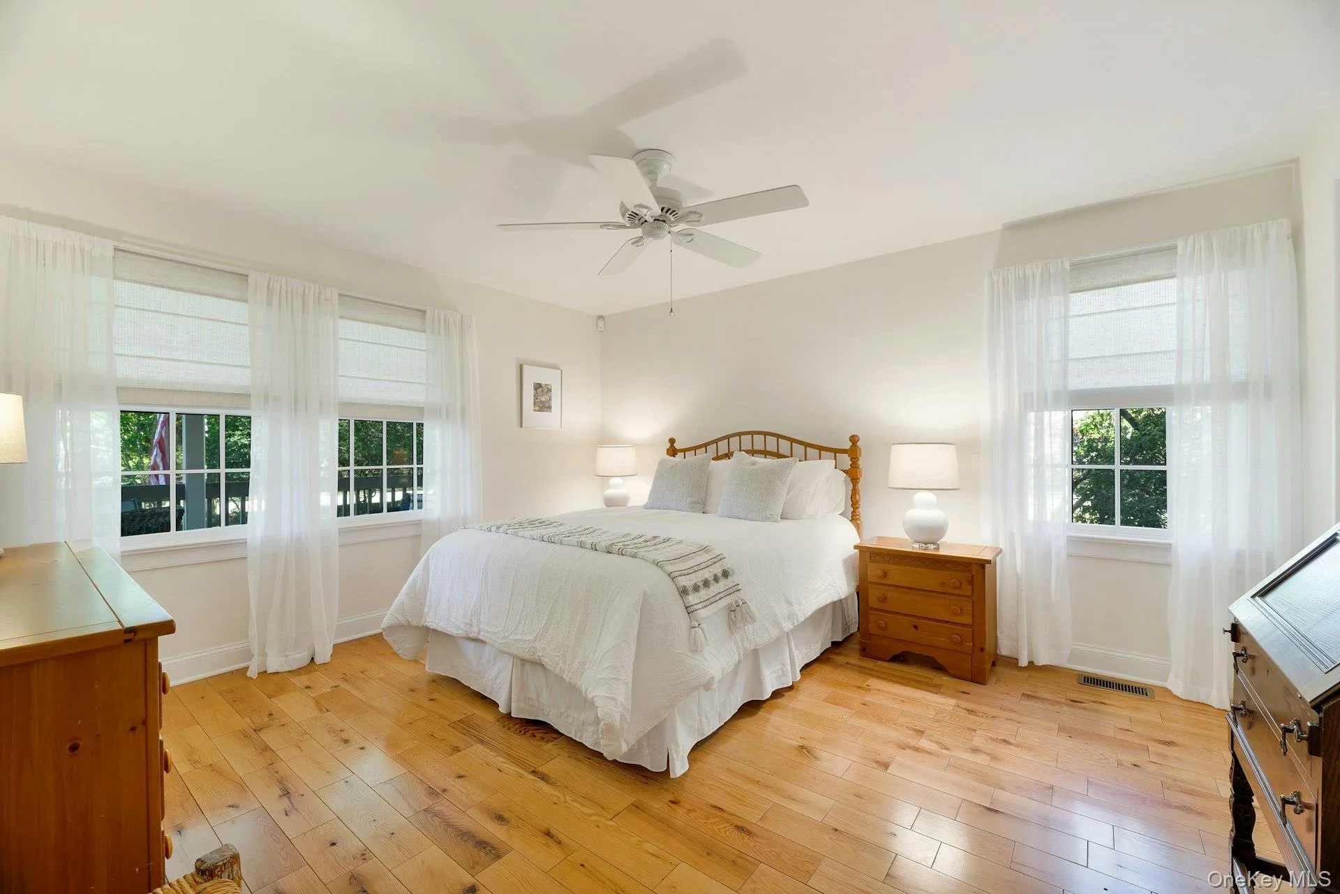 Bedroom featuring light wood-type flooring and a ceiling fan Bedroom featuring light wood-type flooring and a ceiling fan
