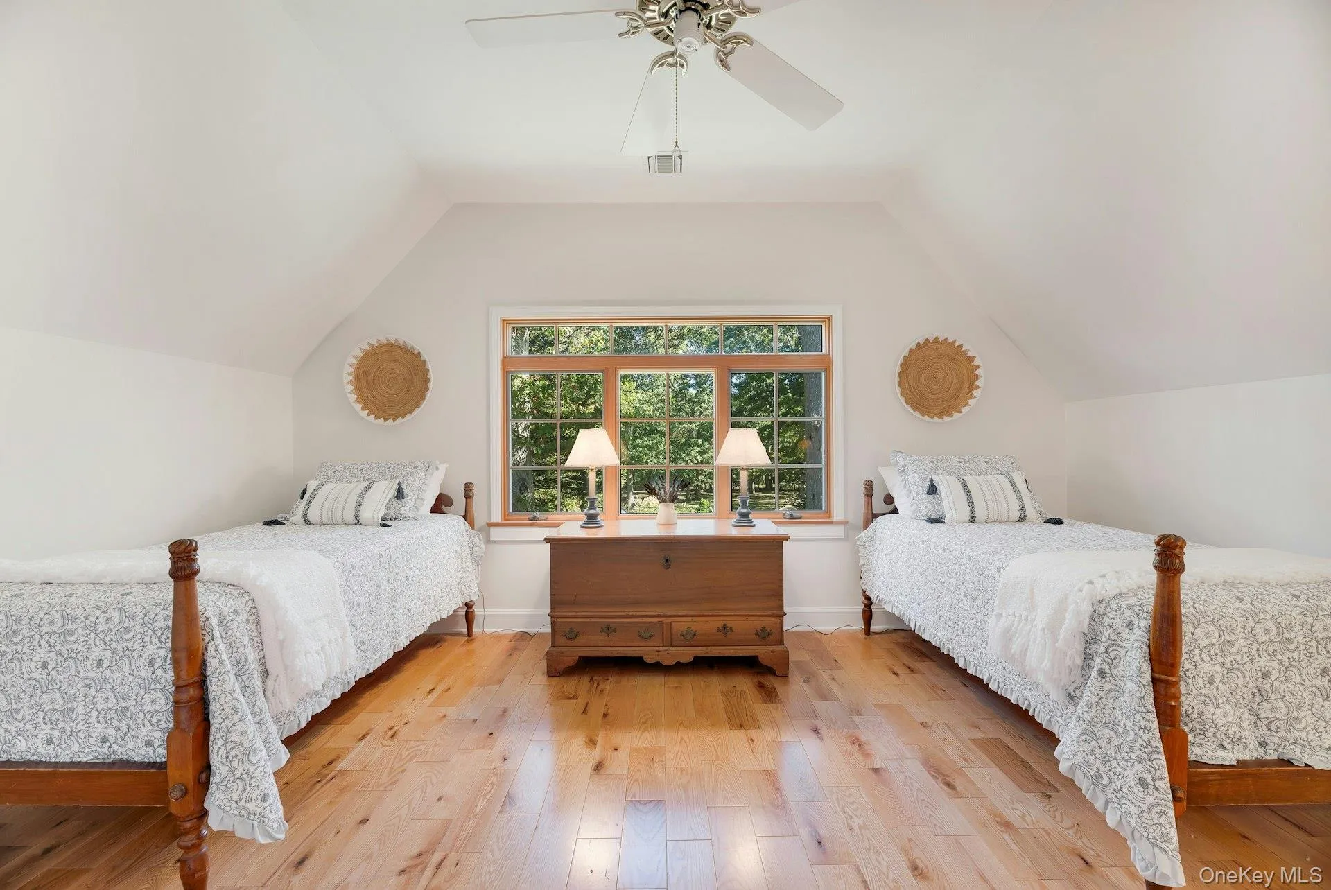 Bedroom featuring vaulted ceiling, light wood finished floors, and ceiling fan Bedroom featuring vaulted ceiling, light wood finished floors, and ceiling fan