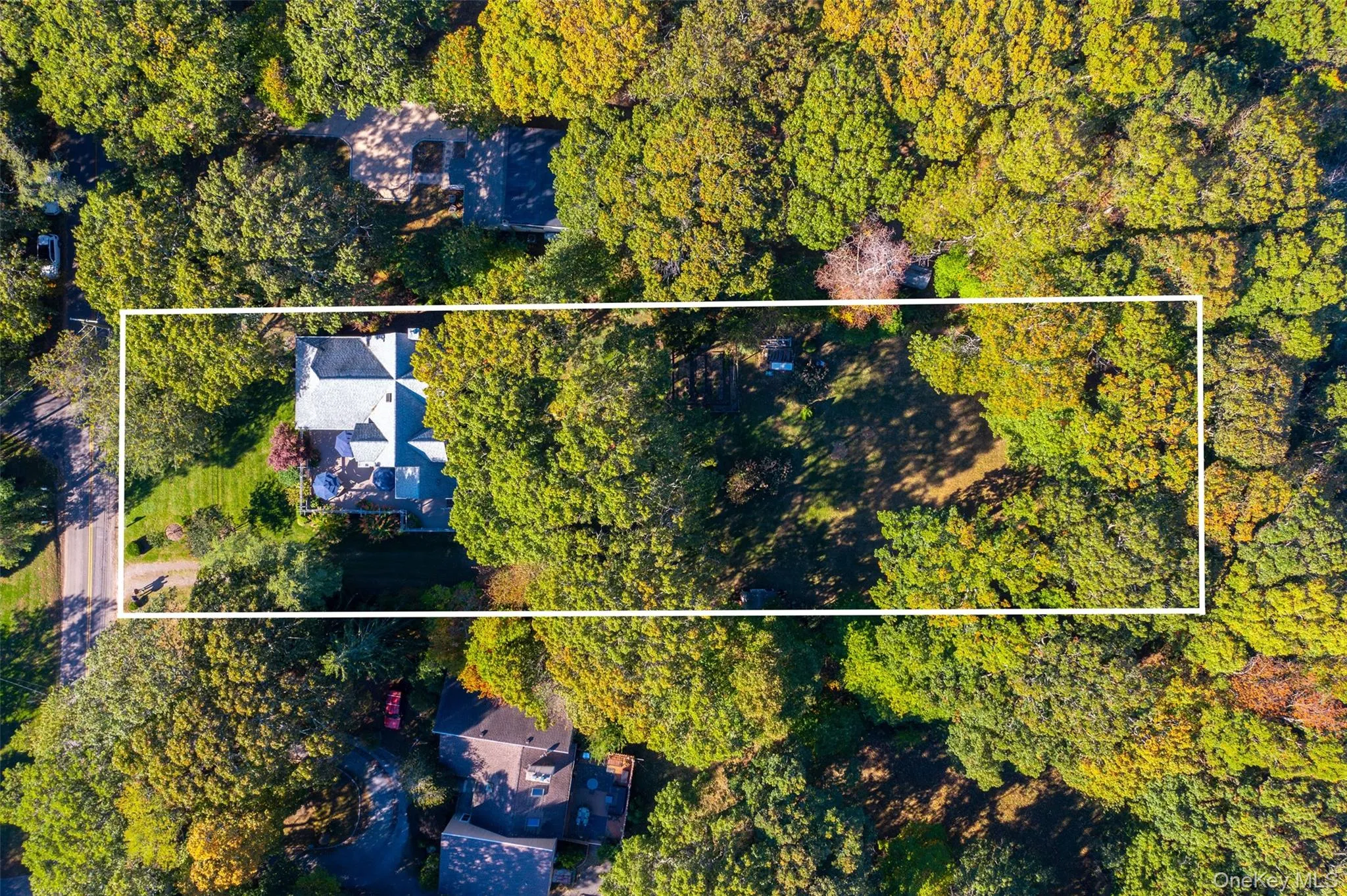 Aerial overview of property's location featuring a forest and property boundaries highlighted Aerial overview of property's location featuring a forest and property boundaries highlighted