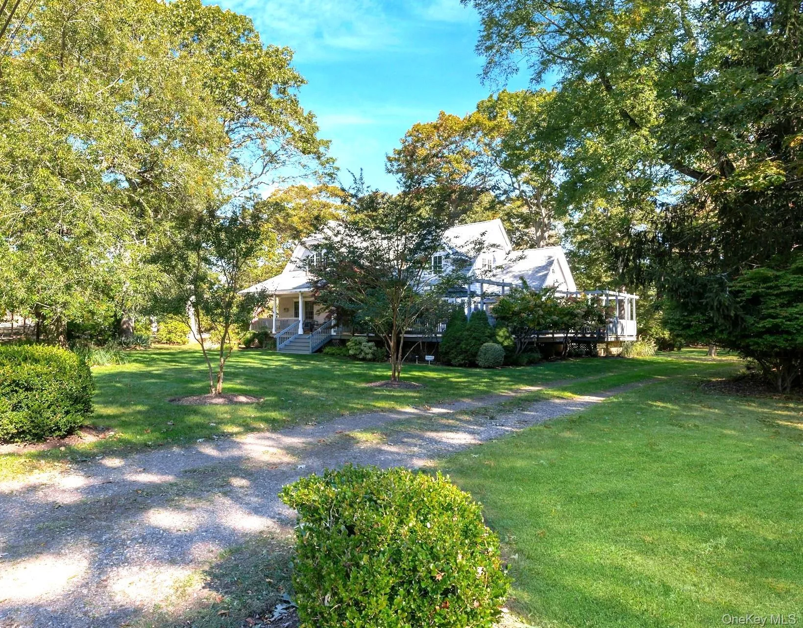 View of green lawn featuring a porch View of green lawn featuring a porch