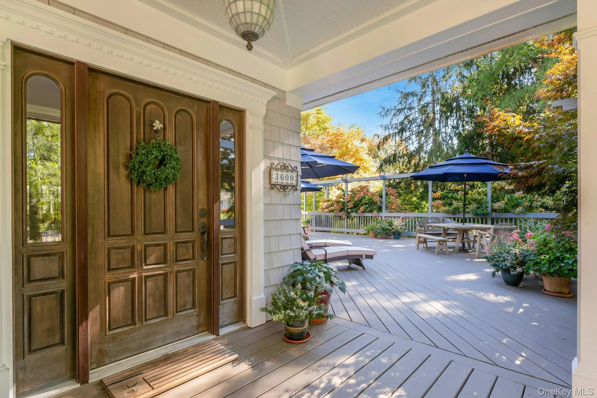 Entrance to property featuring outdoor dining area and a deck Entrance to property featuring outdoor dining area and a deck