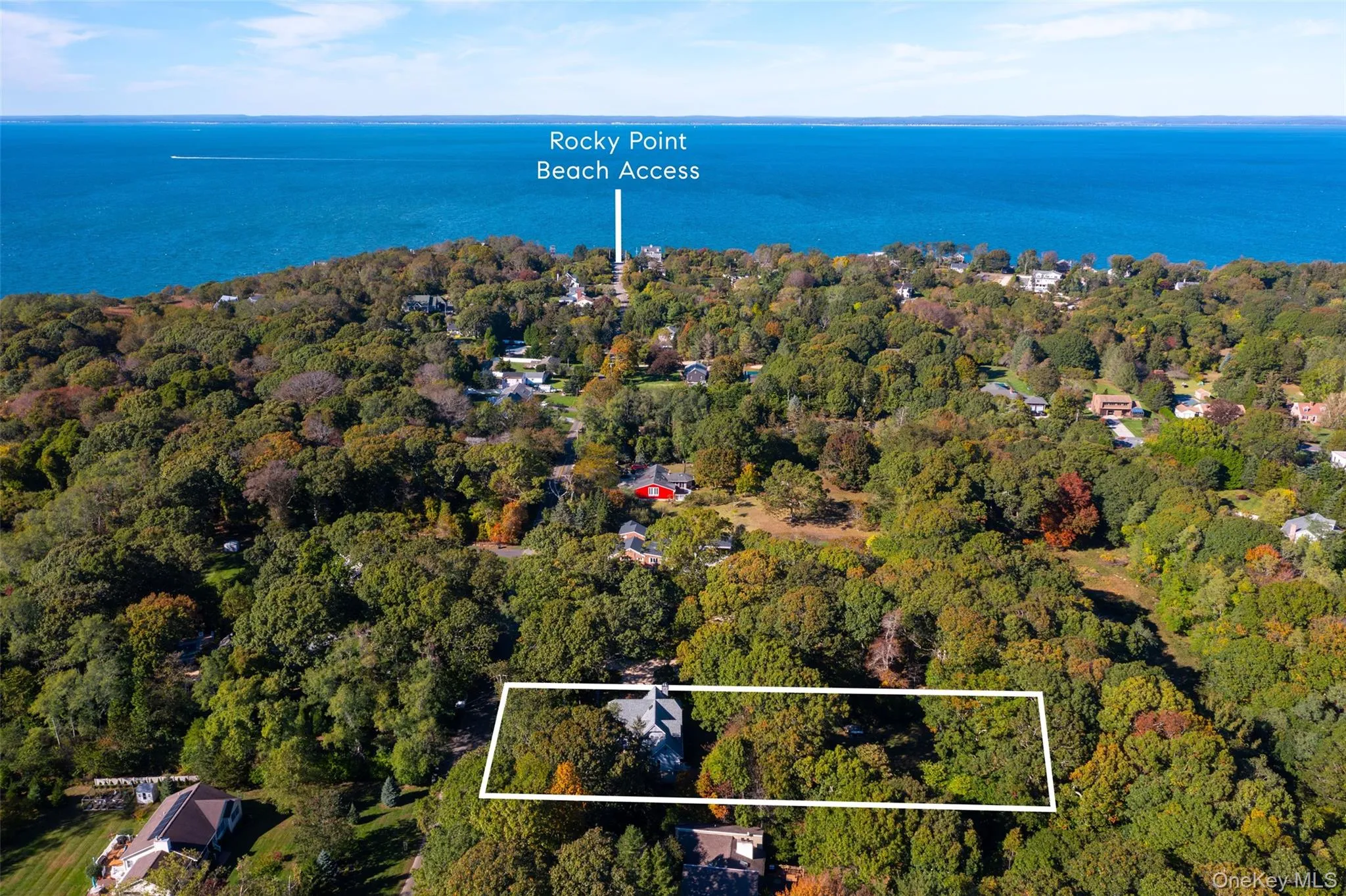 Aerial overview of property's location with a large body of water and property boundaries highlighted Aerial overview of property's location with a large body of water and property boundaries highlighted