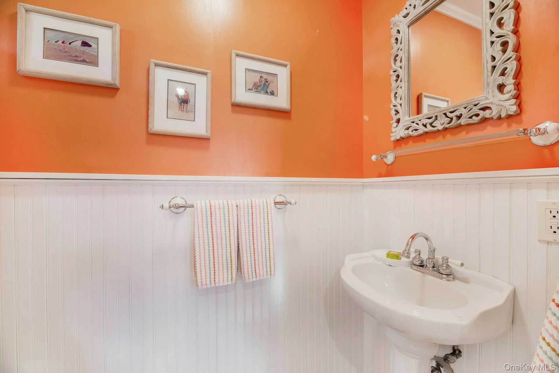 Bathroom with a sink and wainscoting Bathroom with a sink and wainscoting