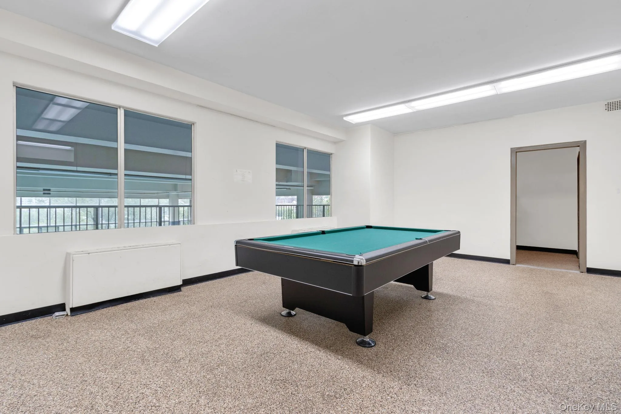 Playroom featuring light colored carpet and pool table Playroom featuring light colored carpet and pool table