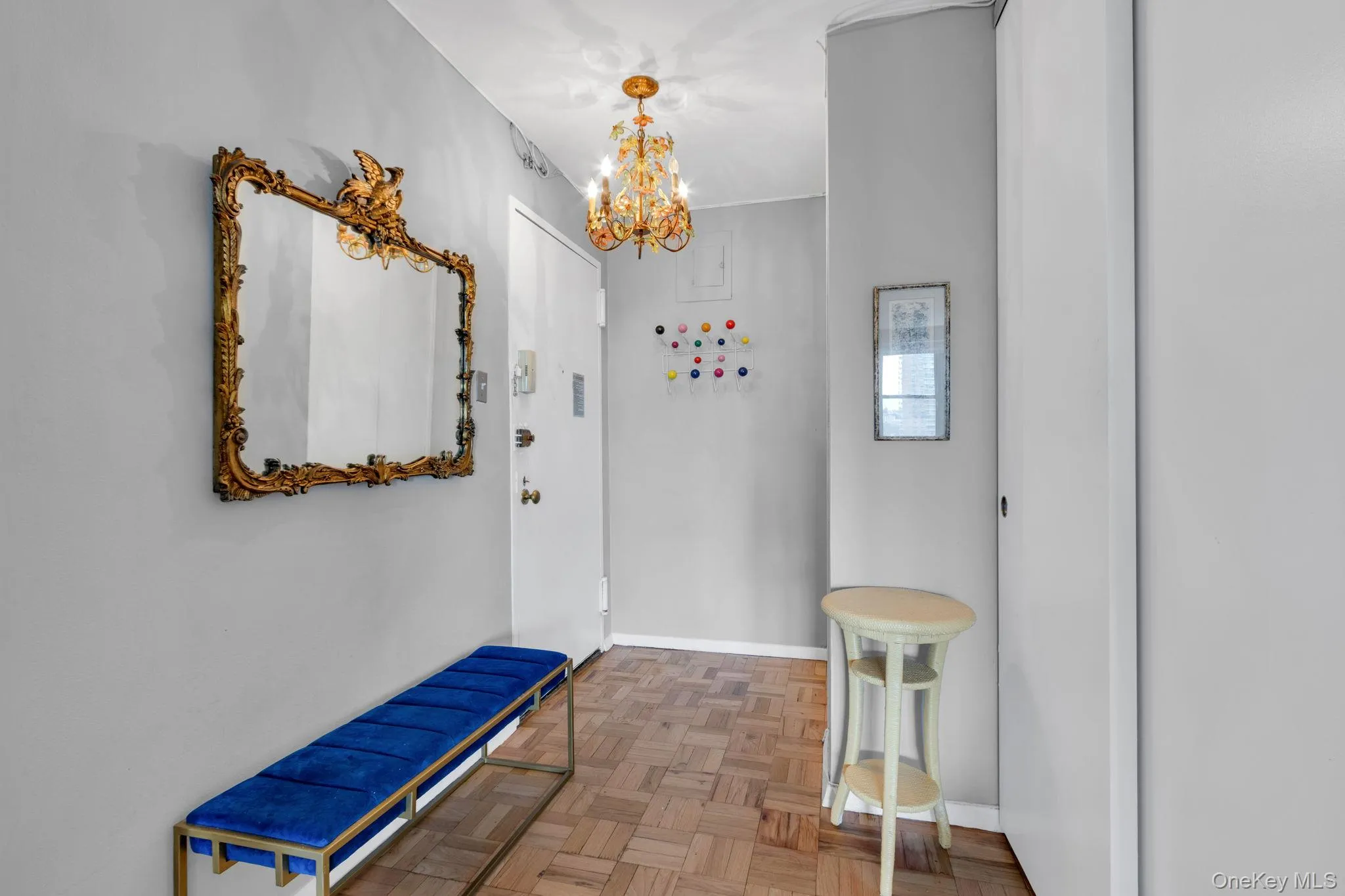Hall featuring a chandelier and baseboards Hall featuring a chandelier and baseboards