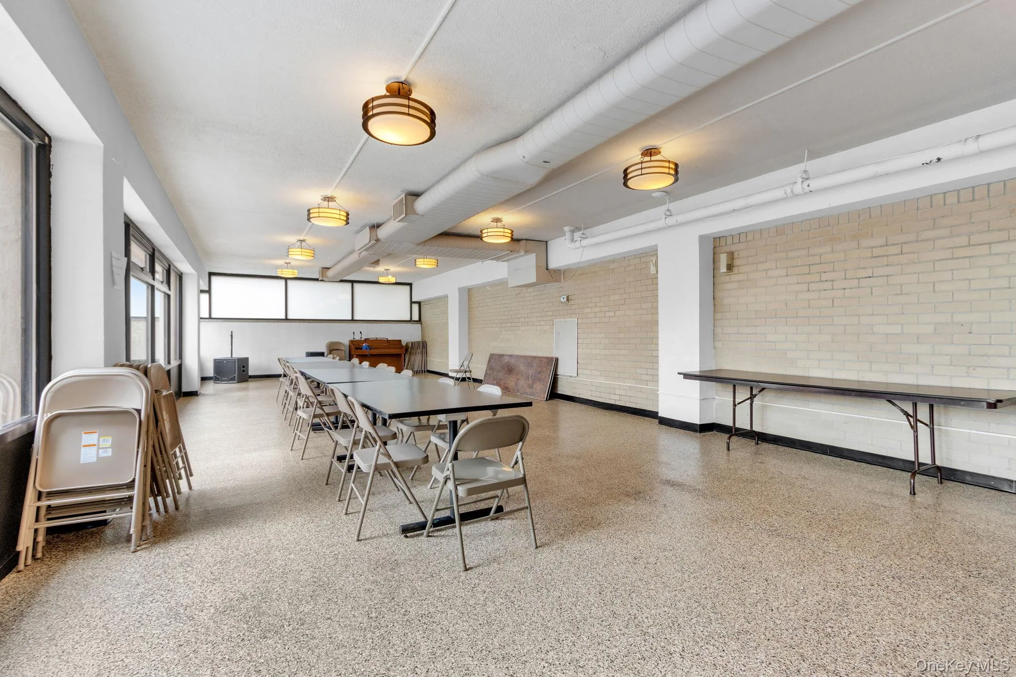 Dining area featuring dark aggregate flooring Dining area featuring dark aggregate flooring