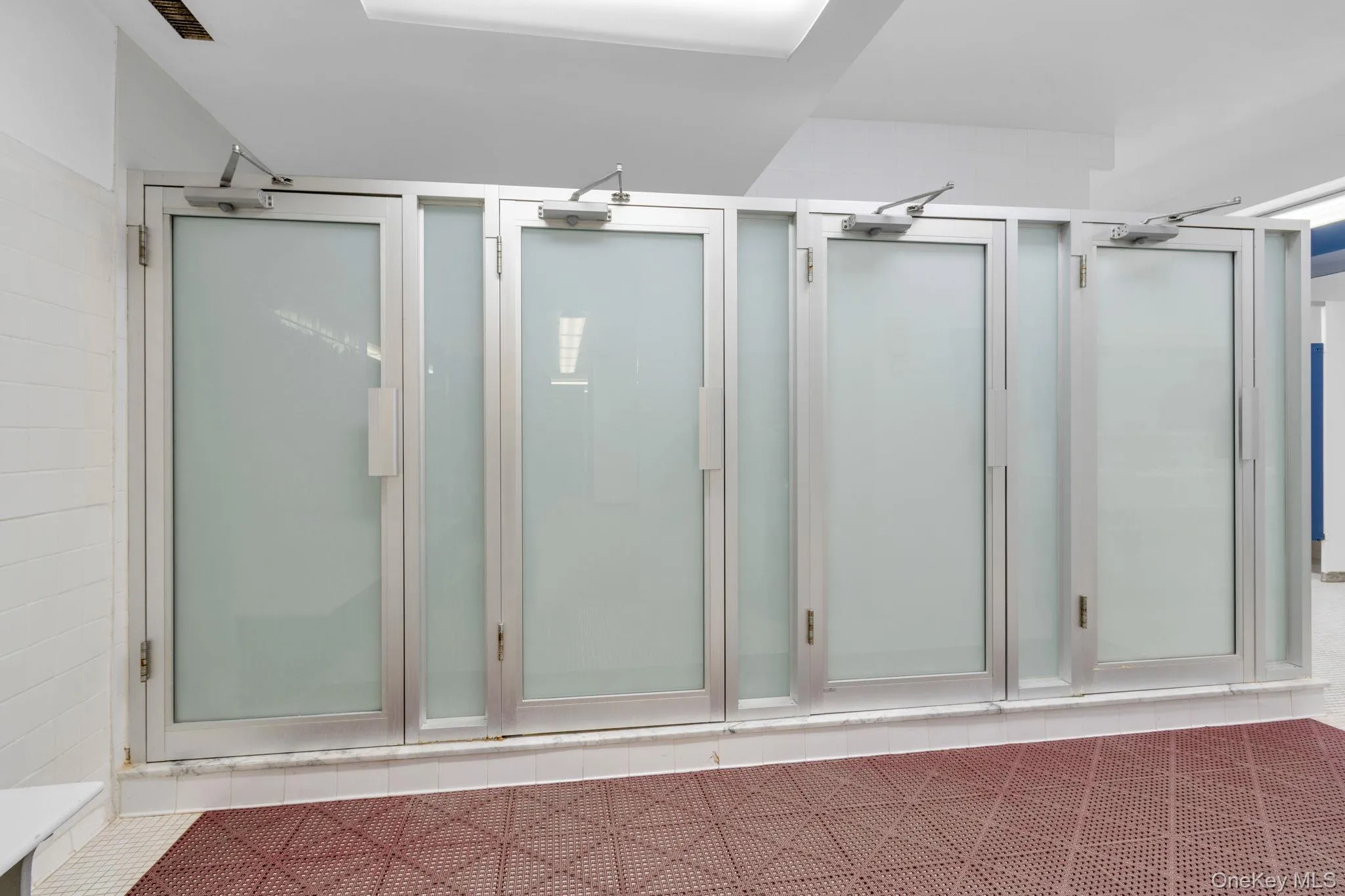 Bathroom featuring tile patterned flooring and a stall shower Bathroom featuring tile patterned flooring and a stall shower