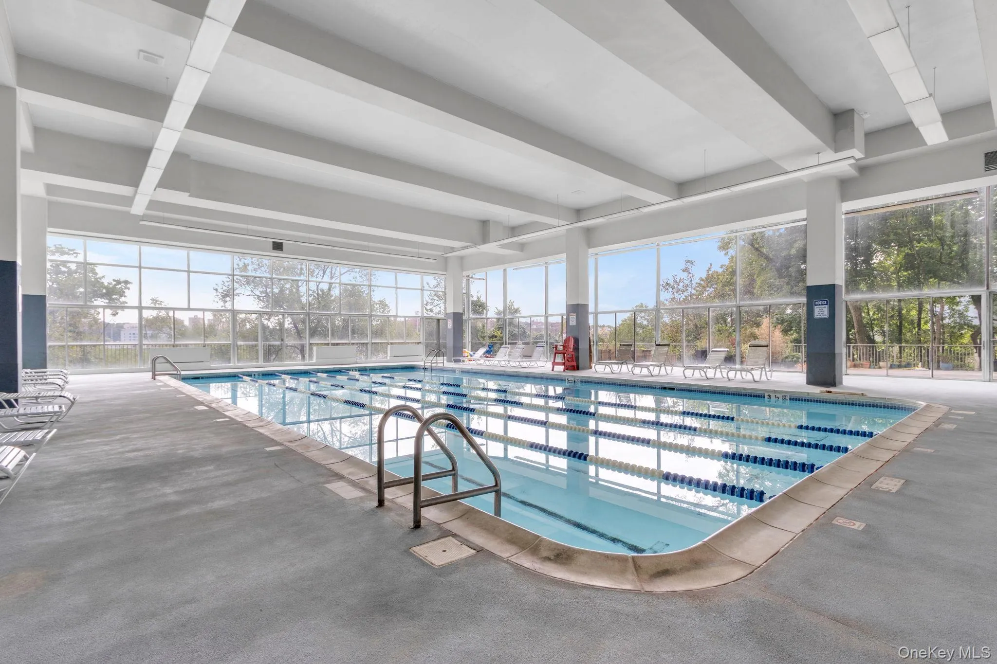 Indoor community pool featuring a patio and a lanai Indoor community pool featuring a patio and a lanai