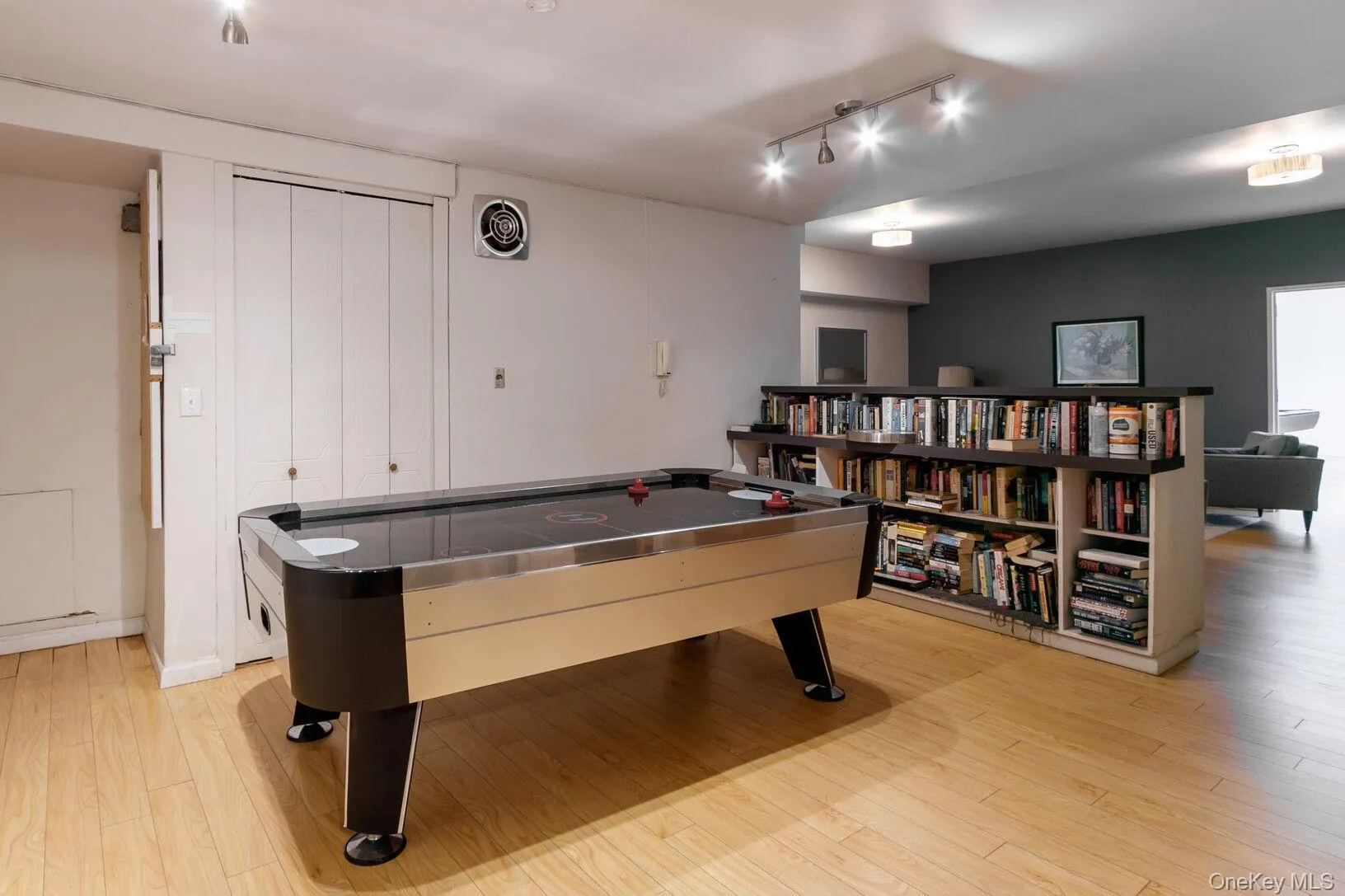 Rec room featuring light wood-style floors and track lighting Rec room featuring light wood-style floors and track lighting