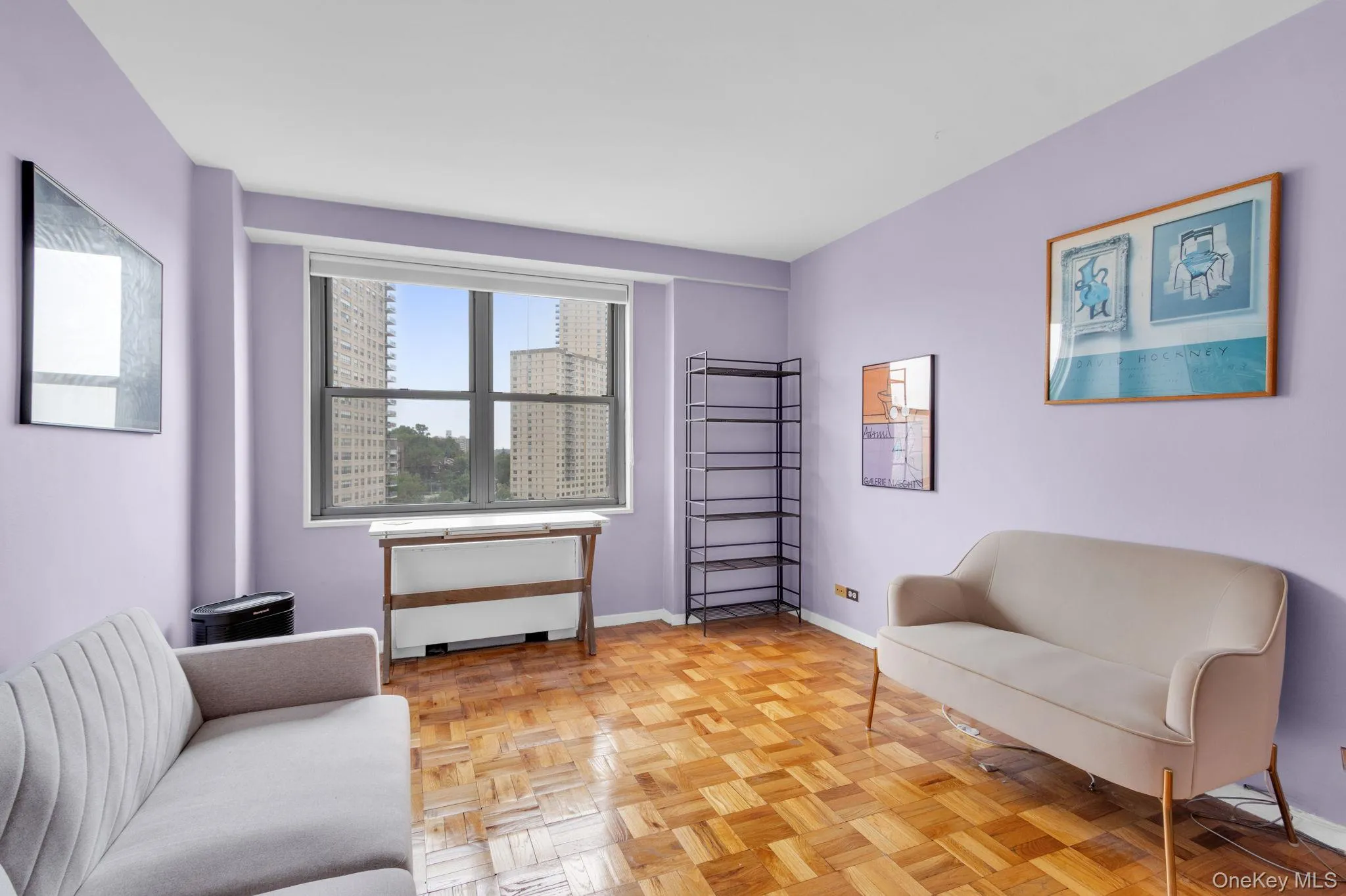 Sitting room featuring baseboards and a city view Sitting room featuring baseboards and a city view