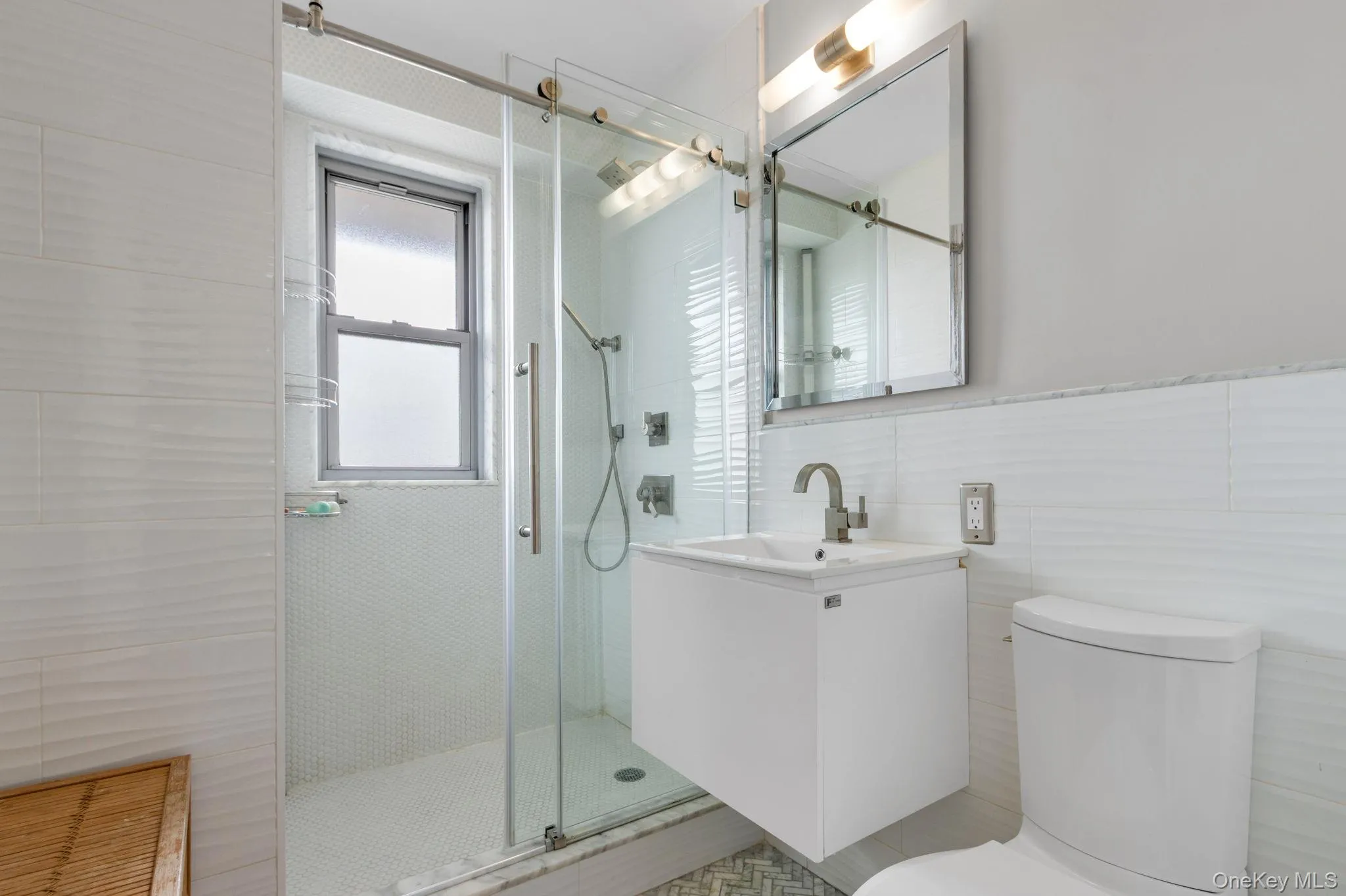 Full bathroom featuring vanity, a shower stall, and tile walls Full bathroom featuring vanity, a shower stall, and tile walls