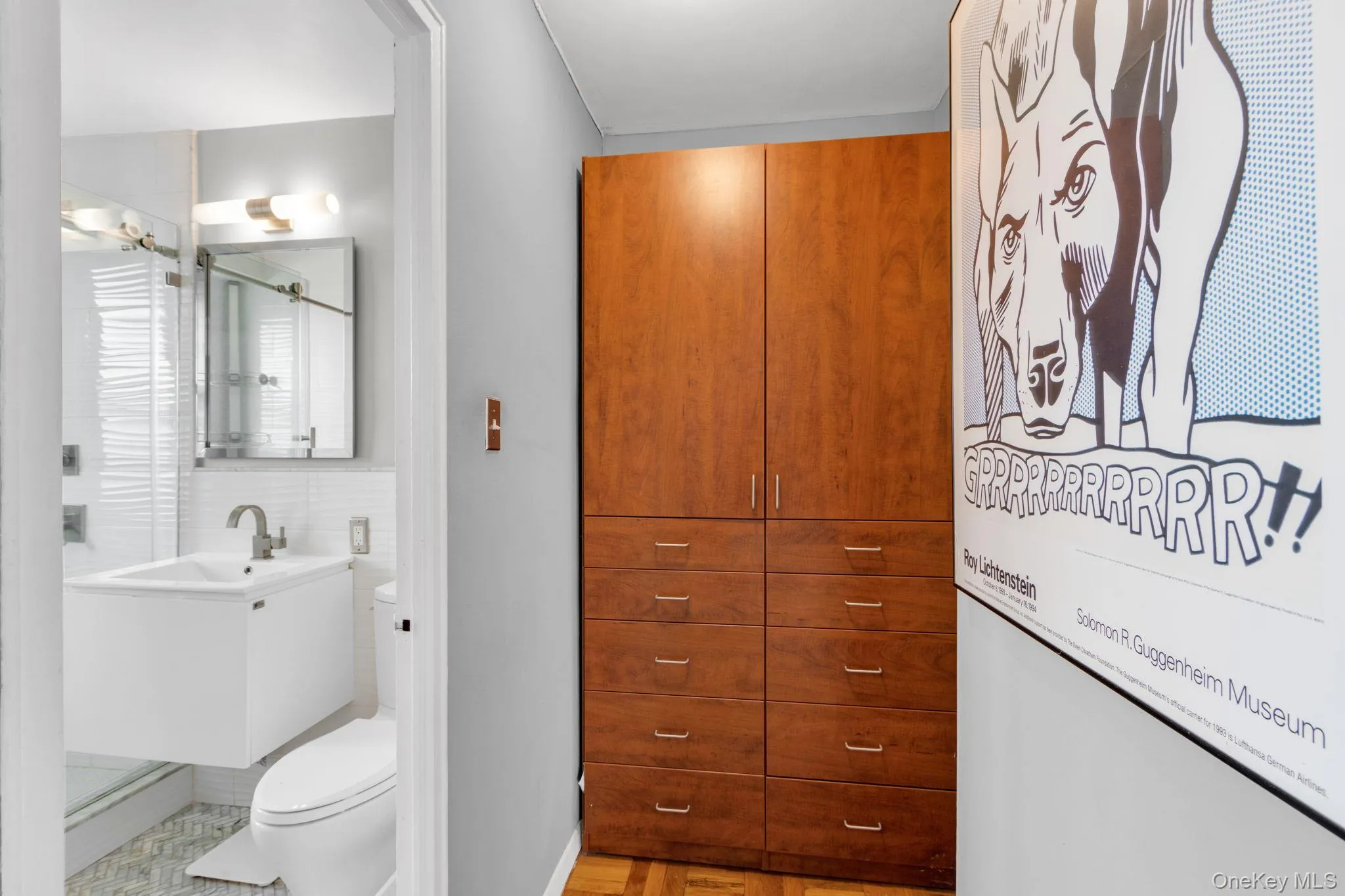 Full bathroom with vanity, a shower stall, and light wood finished floors Full bathroom with vanity, a shower stall, and light wood finished floors