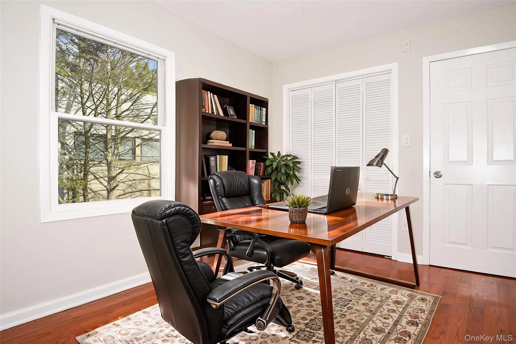 Home office with wood finished floors and baseboards Home office with wood finished floors and baseboards