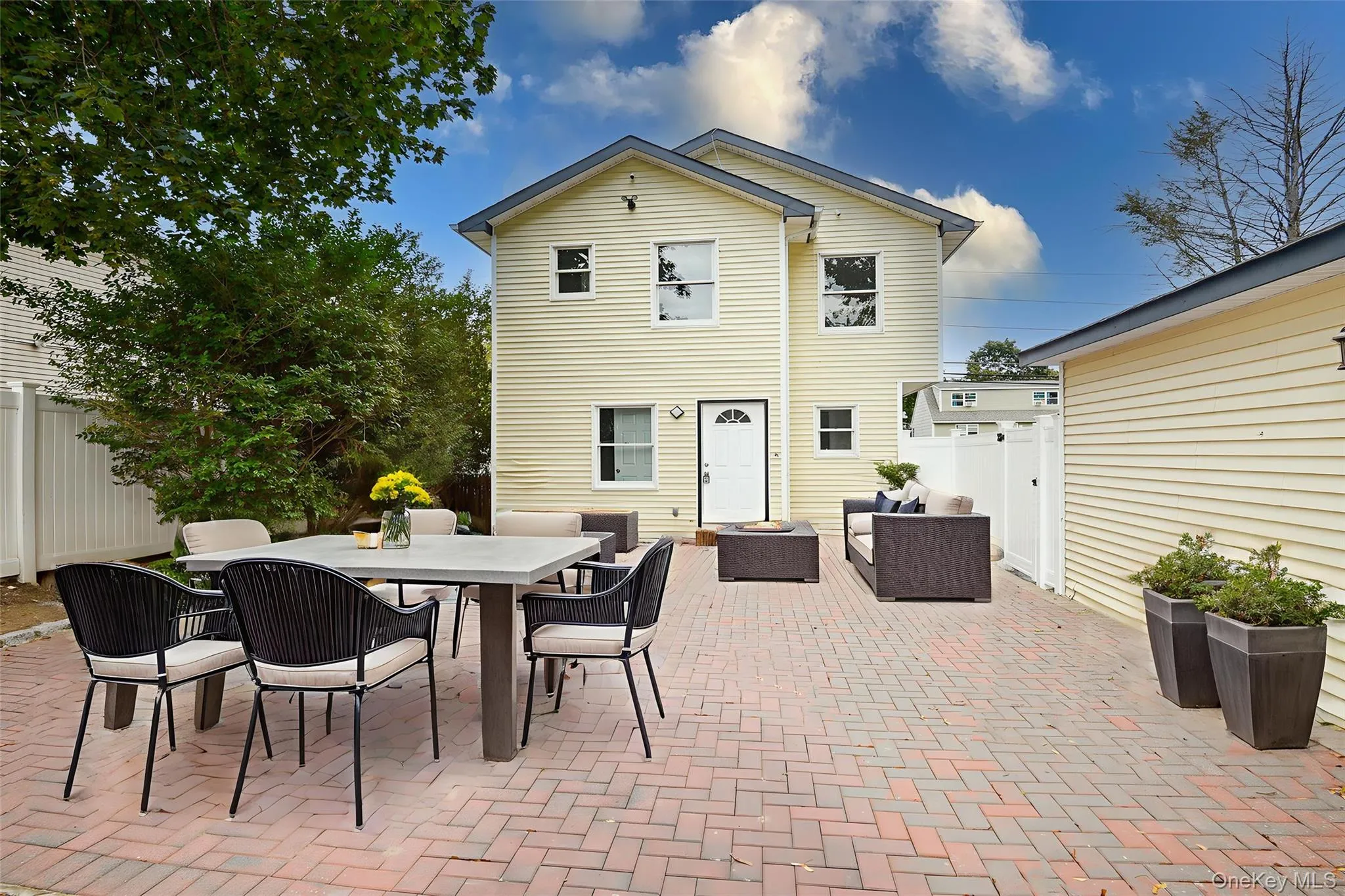 Rear view of house featuring an outdoor living space, a patio area, and outdoor dining area Rear view of house featuring an outdoor living space, a patio area, and outdoor dining area
