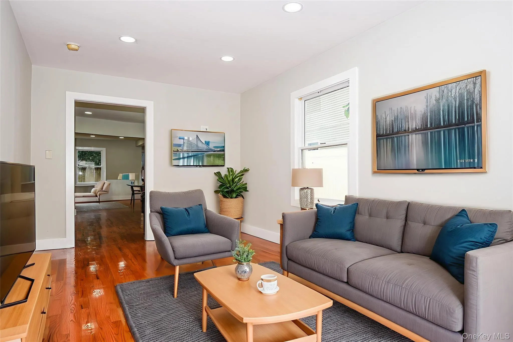 Living room with wood finished floors, recessed lighting, and healthy amount of natural light Living room with wood finished floors, recessed lighting, and healthy amount of natural light