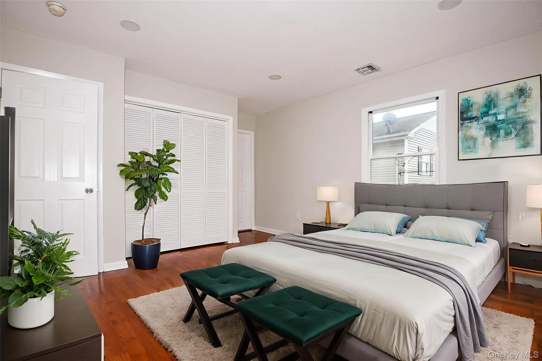 Bedroom featuring dark wood-style floors, a closet, and recessed lighting Bedroom featuring dark wood-style floors, a closet, and recessed lighting