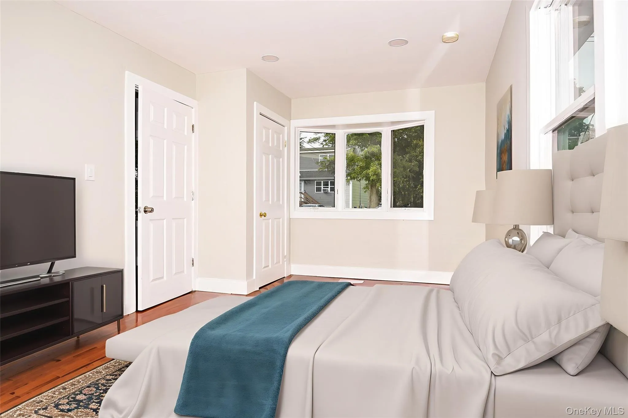 Bedroom featuring wood finished floors Bedroom featuring wood finished floors