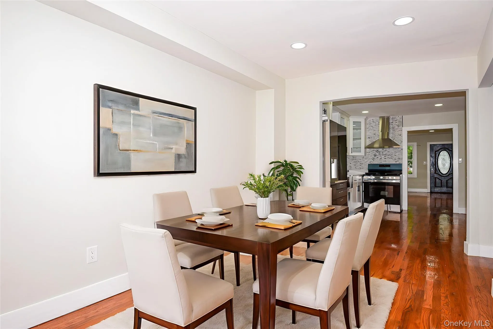 Dining room with dark wood-type flooring and recessed lighting Dining room with dark wood-type flooring and recessed lighting