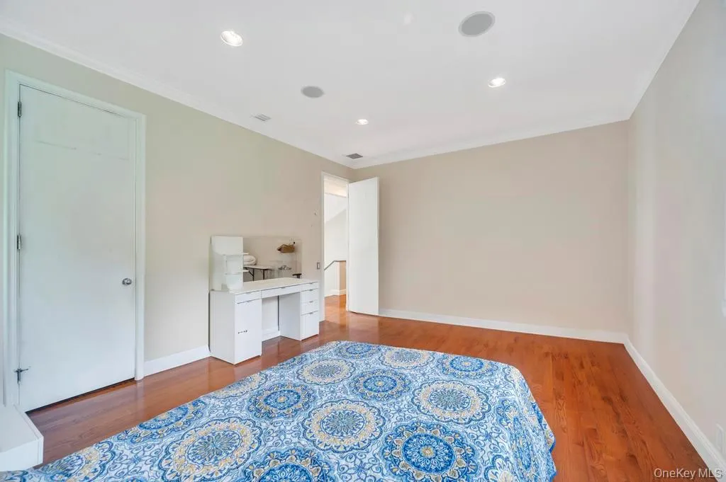 Bedroom featuring crown molding, dark wood-type flooring, recessed lighting, and a desk Bedroom featuring crown molding, dark wood-type flooring, recessed lighting, and a desk