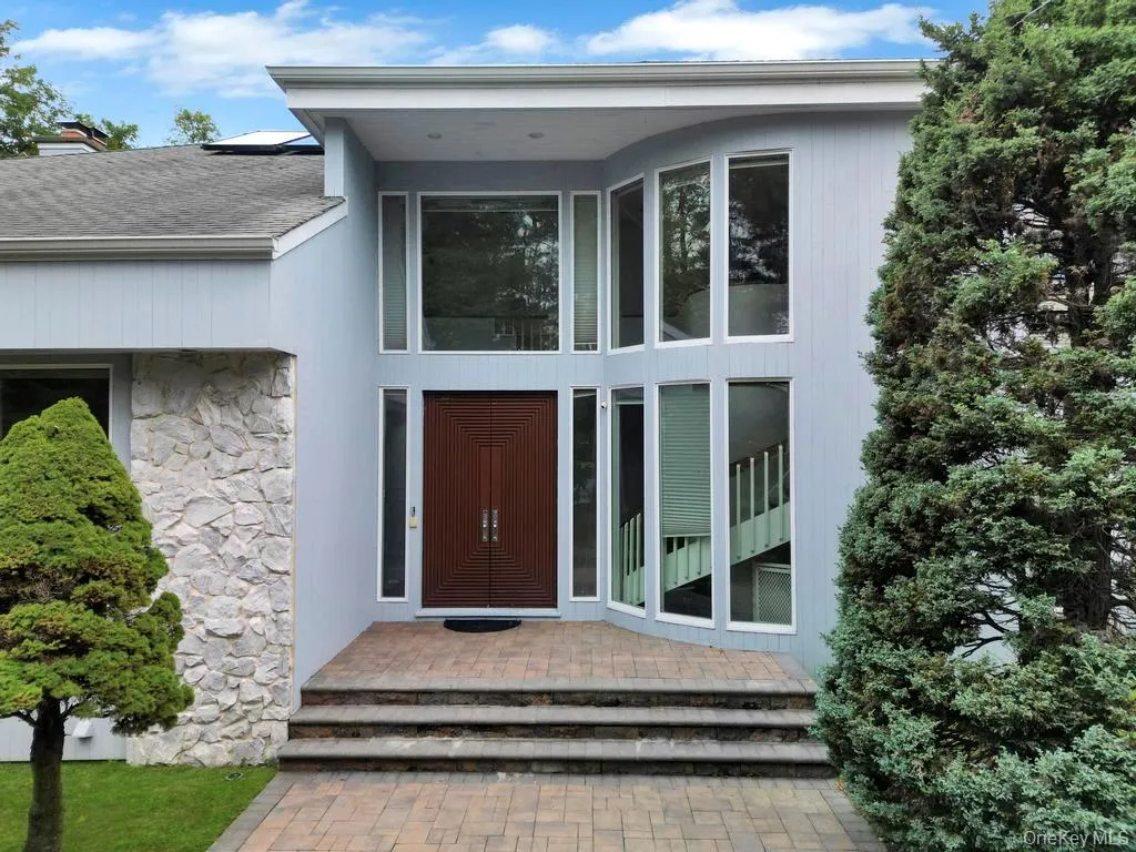 Entrance to property featuring stone siding and a chimney Entrance to property featuring stone siding and a chimney