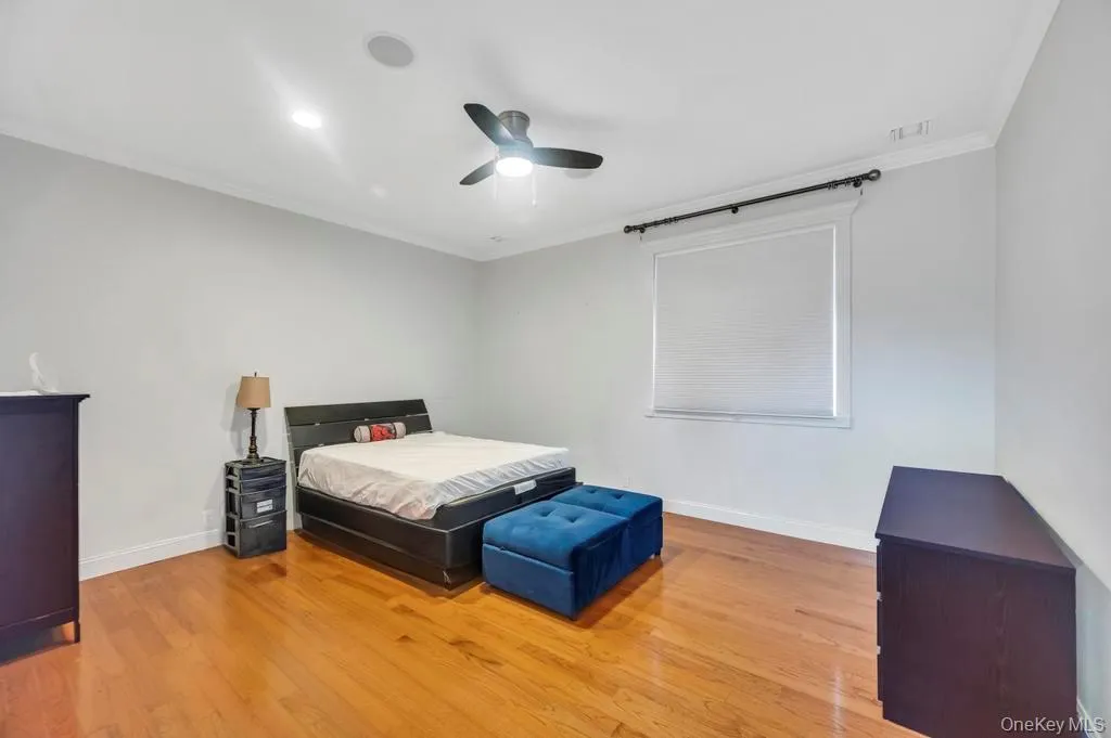 Bedroom with wood finished floors, crown molding, ceiling fan, and recessed lighting Bedroom with wood finished floors, crown molding, ceiling fan, and recessed lighting