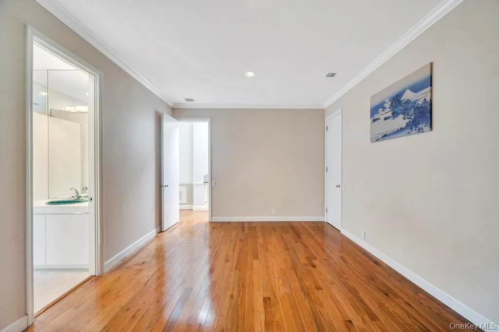 Unfurnished room featuring crown molding, light wood-style flooring, and recessed lighting Unfurnished room featuring crown molding, light wood-style flooring, and recessed lighting