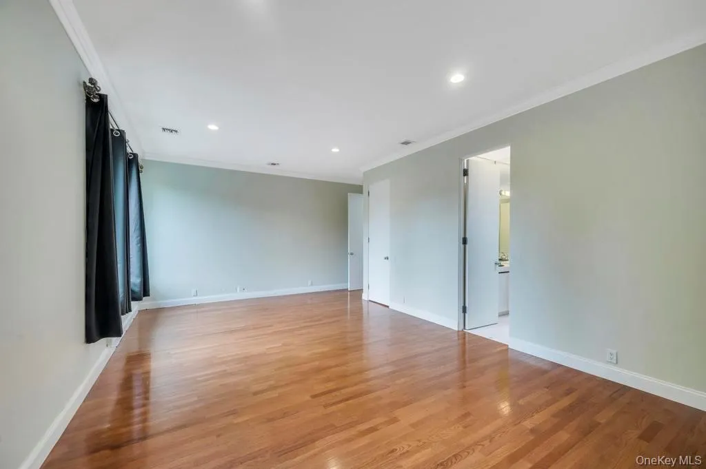 Unfurnished room featuring crown molding, light wood-type flooring, and recessed lighting Unfurnished room featuring crown molding, light wood-type flooring, and recessed lighting